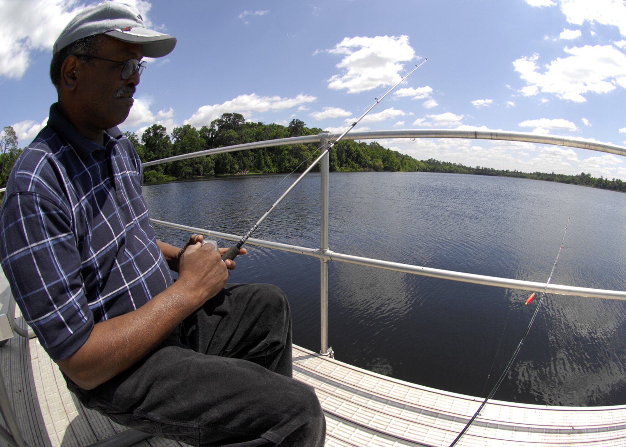 MOODY AIR FORCE BASE, Ga. -- U.S. Navy Retired Chief Petty Officer Jimmy Weatherspoon fishes at Grassy Pond Outdoor Recreation Area near Moody Air Force Base, Ga., April 23. Many retired military members frequent Grassy Pond for the variety of facilities and activities offered there. (U.S. Air Force Photo by Senior Airman Elizabeth Rissmiller) 