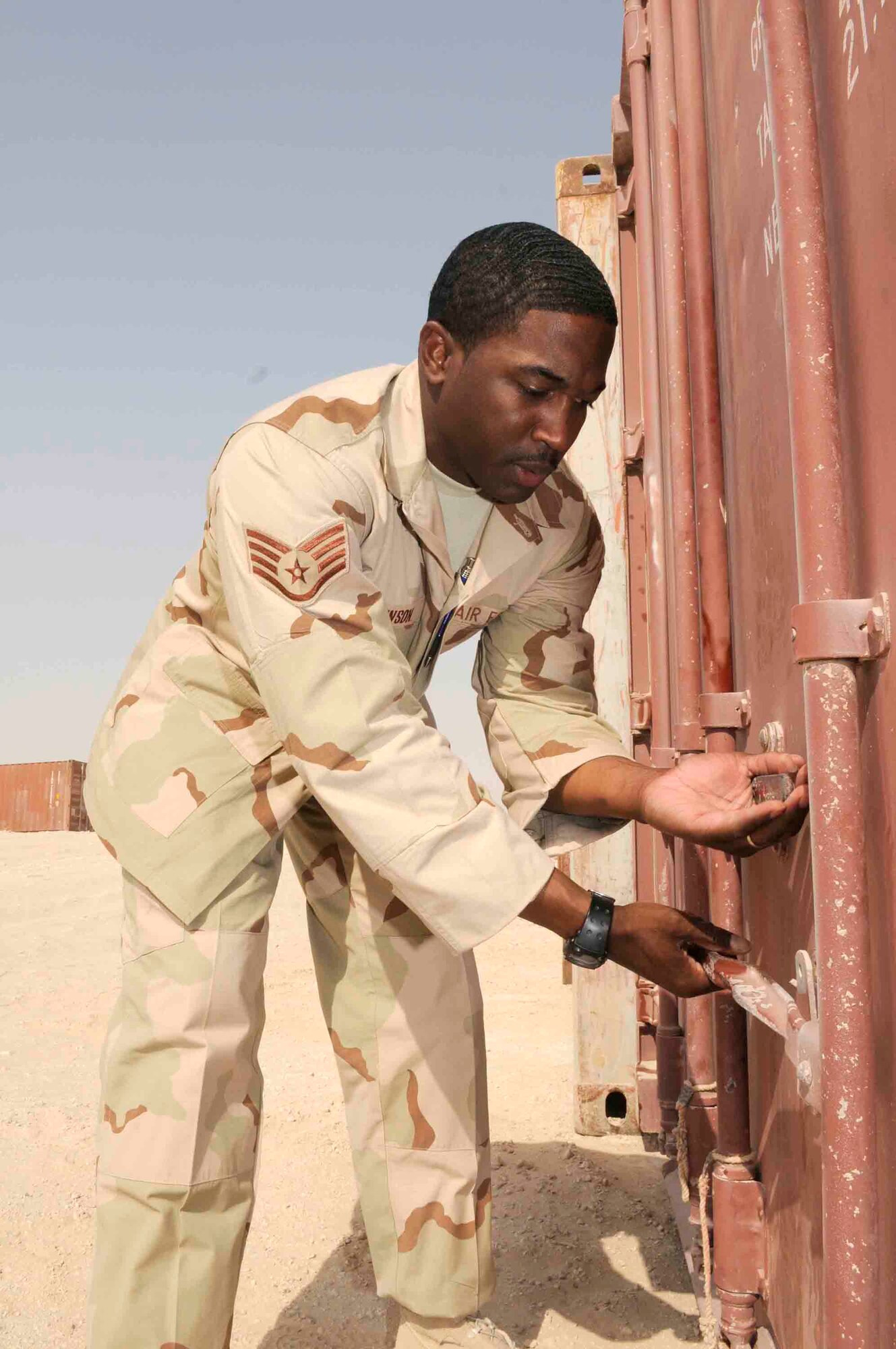 Staff Sgt. Maurice Johnson, 379th Expeditionary Logistics Readiness Squadron, opens a storage container to ensure it is ready for transport at a Southwest Asia air base April 24. The 379th ELRS has removed more than 500 storage containers in less than 60 days. (U.S. Air Force photo by Tech. Sgt. Johnny Saldivar.)