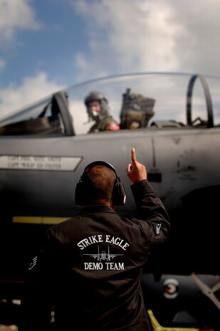 A F-15 Strike Eagle crew chief signals the pilot of the F-15E after he arrives on Charleston AFB for the 2008 "Wings Over Charleston" Air Expo April 24. The biennial expo hosted by the 437th Airlift Wing will allow Americans the opportunity to meet and greet Airmen and view civilian and military aircraft.  (U.S. Air Force Photo/Senior Airman Nicholas Pilch)