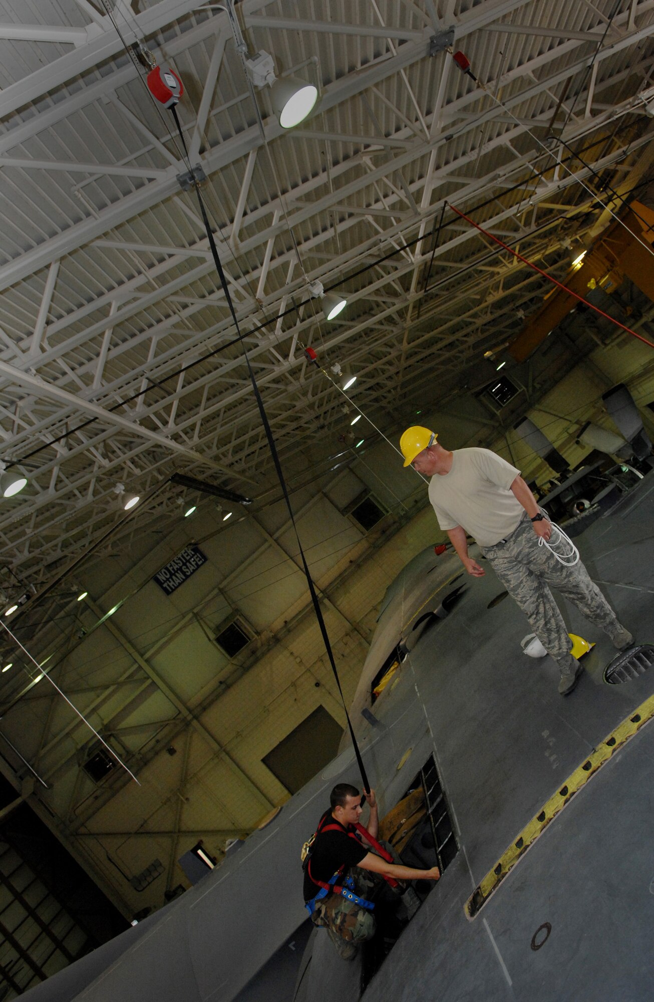 MOODY AIR FORCE BASE, Ga. -- Airman 1st Class Michael Sharp, 23rd Equipment Maintenance Squadron HC-130P King crew chief, performs checks on an HC-130P Hercules while connected to a safety restraint system here April 21. The restraint system, which is an inertia activated system, locks when it feels the initial jerk and stretches to prevent serious injury. (U.S. Air Force photo by Senior Airman Gina Chiaverotti) 
