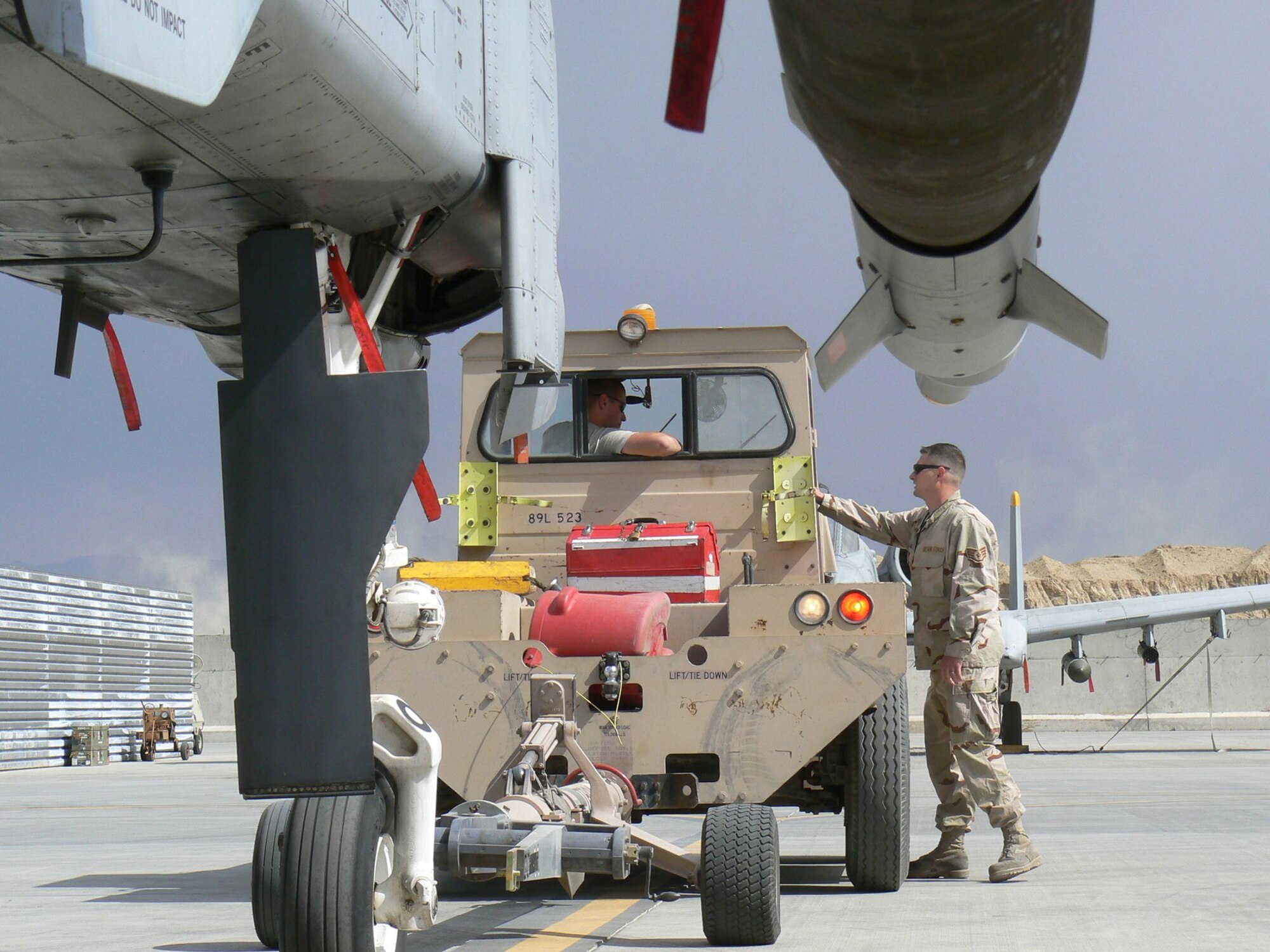 BAGRAM AIR BASE, Afghanistan –Senior Airman Tristan Bacom tows an A-10 Thunderbolt II while Staff Sgt. Damon Ballard supervises the operation. Both crew chiefs are assigned to the 81st Expeditionary Aircraft Maintenance Unit and are deployed from Spangdahlem Air Base, Germany. (U.S. Air Force photo/Senior Airman Eric Gibson)