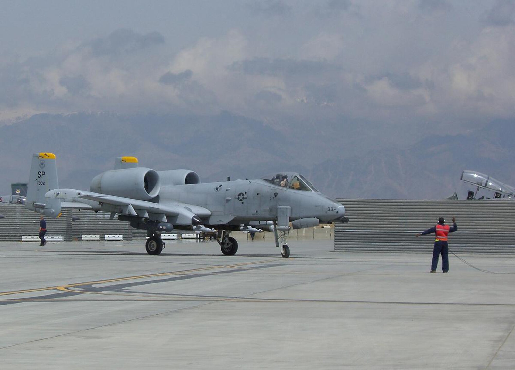 BAGRAM AIR BASE, Afghanistan – Senior Airman Troy Brown marshals an A-10 Thunderbolt II onto the end of the runway for de-arming after a combat sortie. Airman Brown and the A-10 are deployed from Spangdahlem Air Base, Germany.  (U.S. Air Force photo/Capt. Jennifer Gurganus)