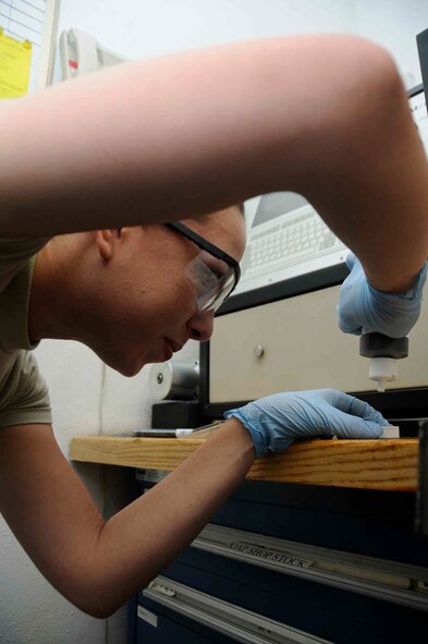 SOUTHWEST ASIA—Senior Airman Cori Lester prepares an oil sample for inspection of wear metals April 23. The NDI flight tests the oil every 50 flying hours to detect waste materials that may be harmful to an aircraft engine (?). (U.S. Air Force photo/ Senior Airman Domonique Simmons)