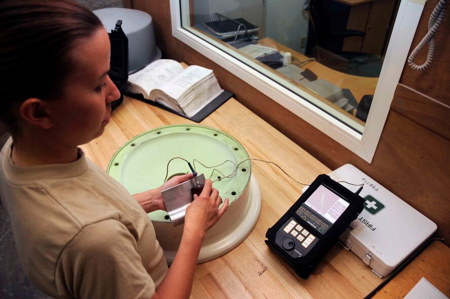 SOUTHWEST ASIA- Staff Sgt. Sarah Straughn, an NDI craftsman, uses an Eddy current on a KC-135 nose wheel April 23. The Eddy current detects cracks by using electrical currents. (U.S. Air Force photo/ Senior Airman Domonique Simmons)
