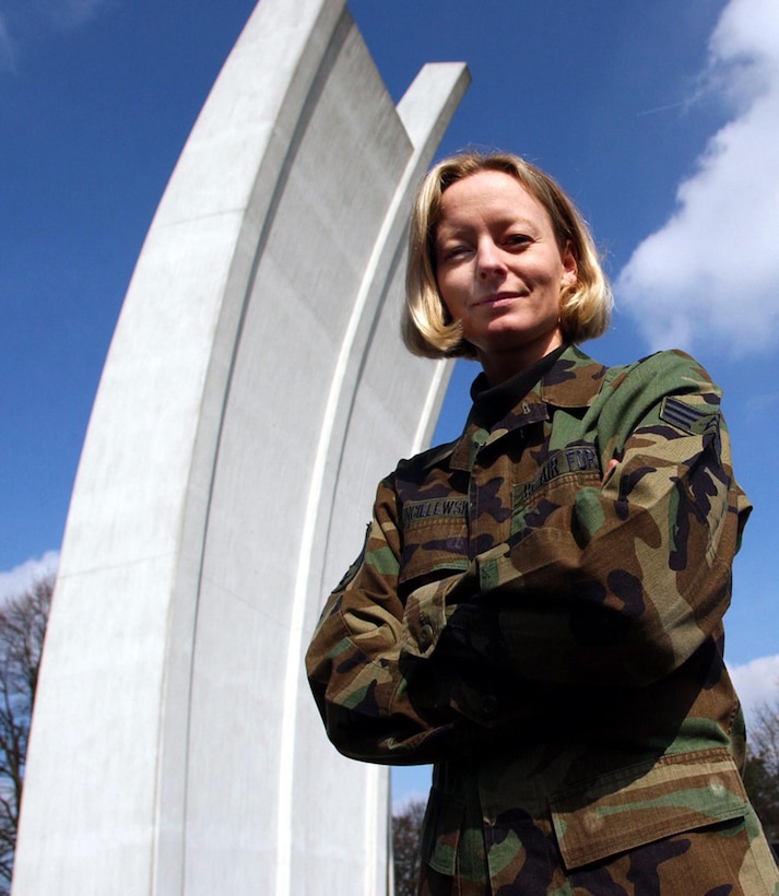 U.S. Air Force Senior Airman Anke Dzincielewski pauses near the Berlin Airlift Memorial on Rhein-Main Air Base, on March 24, 2003.  Dzincielewski grew up in East Germany and remembers life before the Berlin Wall came down.  