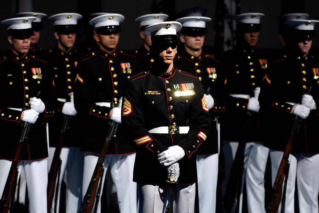 U.S. Marines stand in formation during a retirement ceremony for Army ...