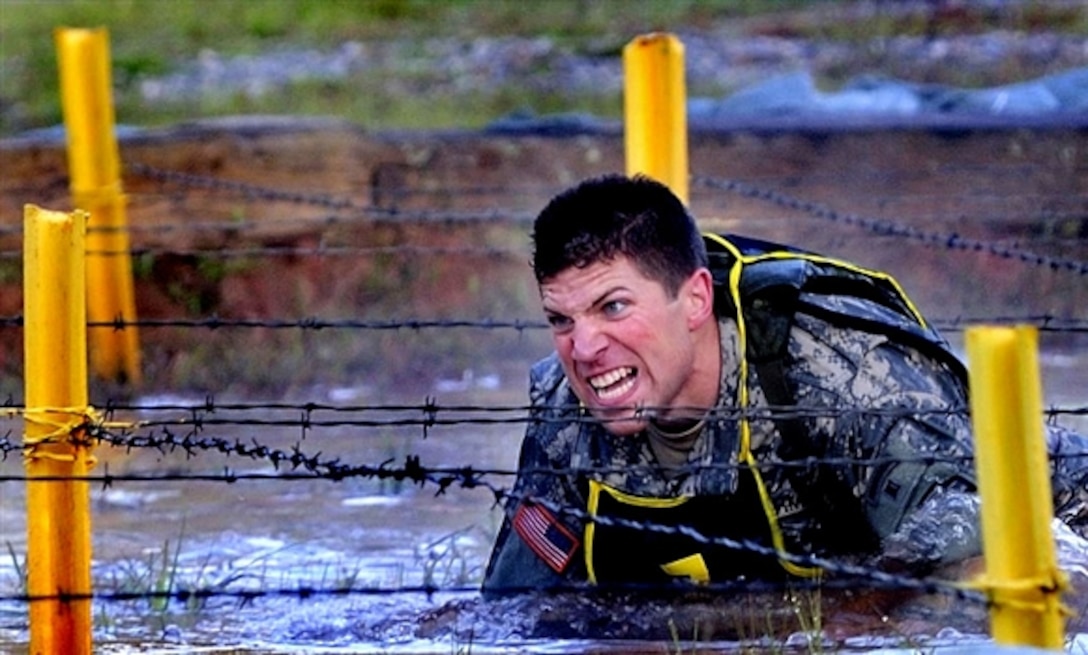 U.S. Army Sgt. Andrew Fuccillo of team 7 representing the 75th Ranger Regiment pushes himself through frigid water and barbed wire in the early morning hours of the 2008 Best Ranger Competition, April 18, 2008, at Fort Benning, Ga. 
