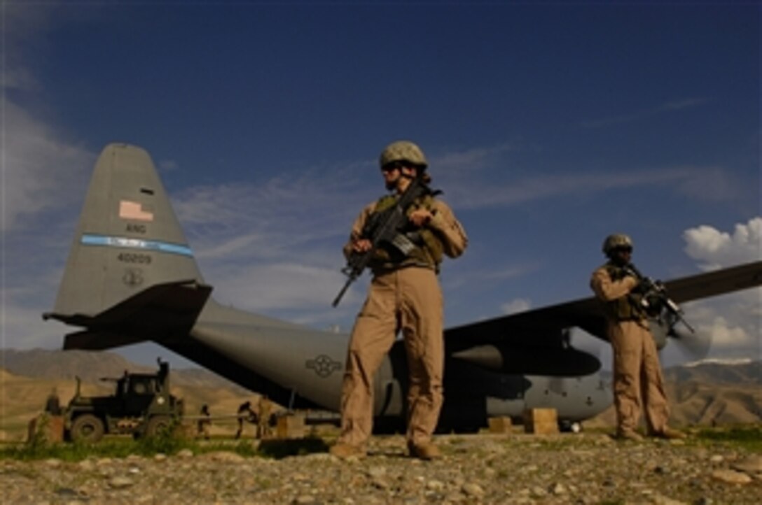 U.S. Air Force Airman 1st Class Kelliea Guthrie (left) and Senior Airman Greg Ellis provide security for a C-130 Hercules aircraft during a cargo mission at Feyzabab Airfield in Afghanistan on April 23, 2008.  Guthrie is deployed from the 9th Security Forces Squadron, Beale Air Force Base, Calif., and Ellis is deployed from the 355th Security Forces Squadron, Davis-Monthan Air Force Base, Ariz.  Both airmen are part of the Fly Away Security Forces Team assigned to the 455th Expeditionary Security Forces. 