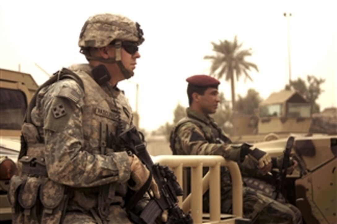 U.S. Army Sgt. Matt Radcliffe  provides security at an Iraqi army patrol base in the Sadr City district of Baghdad along with an Iraqi army soldier from the 42nd Brigade, 11th Iraqi Army Division April 19, 2008. Radcliffe is assigned to the  4th Infantry Division's3rd Special Troops Battalion, 3rd Brigade Combat Team.