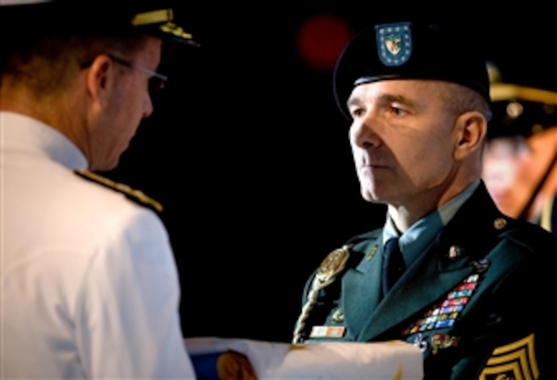 U.S. Navy Adm. Mike Mullen, chairman of the Joint Chiefs of Staff, presents U.S. Army Command Sgt. Maj. William J. Gainey, senior enlisted advisor (SEAC) to the chairman of the Joint Chiefs of Staff, with the SEAC flag during Gainey's retirement ceremony, Fort Myer, Arlington, Va., April 25, 2008. Gainey retired after 33 years of service.