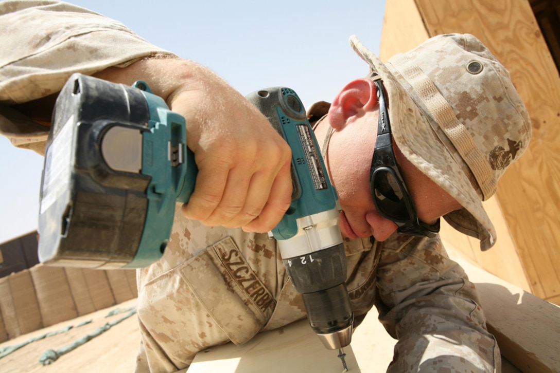 Cpl. Nicholas L. Szczerba, 22, a  rifleman with 3rd Battalion, 4th Marine Regiment, Regimental Combat Team 5, from Shingle Springs, Calif., drills two pieces of wood together while constructing a door at Combat Outpost Haditha, Iraq, April 25. Szczerba has become the a "go-to-guy" for Marines. He fills multiple billets for the battalion such as the assistant Camp Commandant, sergeant of the guard and police sergeant. Marines aboard COP Haditha know that if they want something done, Szczerba is the man with whom to talk.