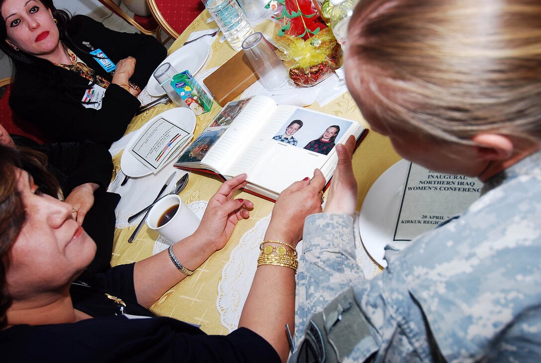 The dialogue remained light with more interest in getting to know one another as Soldiers and Airmen brought photo albums, sharing pictures of family and friends with attendees, who in turn, shared theirs at the Inaugural Northern Iraq Women's Conference held April 20, at FOB Warrior, Kirkuk, Iraq. (U.S. Army photo by Staff Sgt. Margaret C. Nelson)