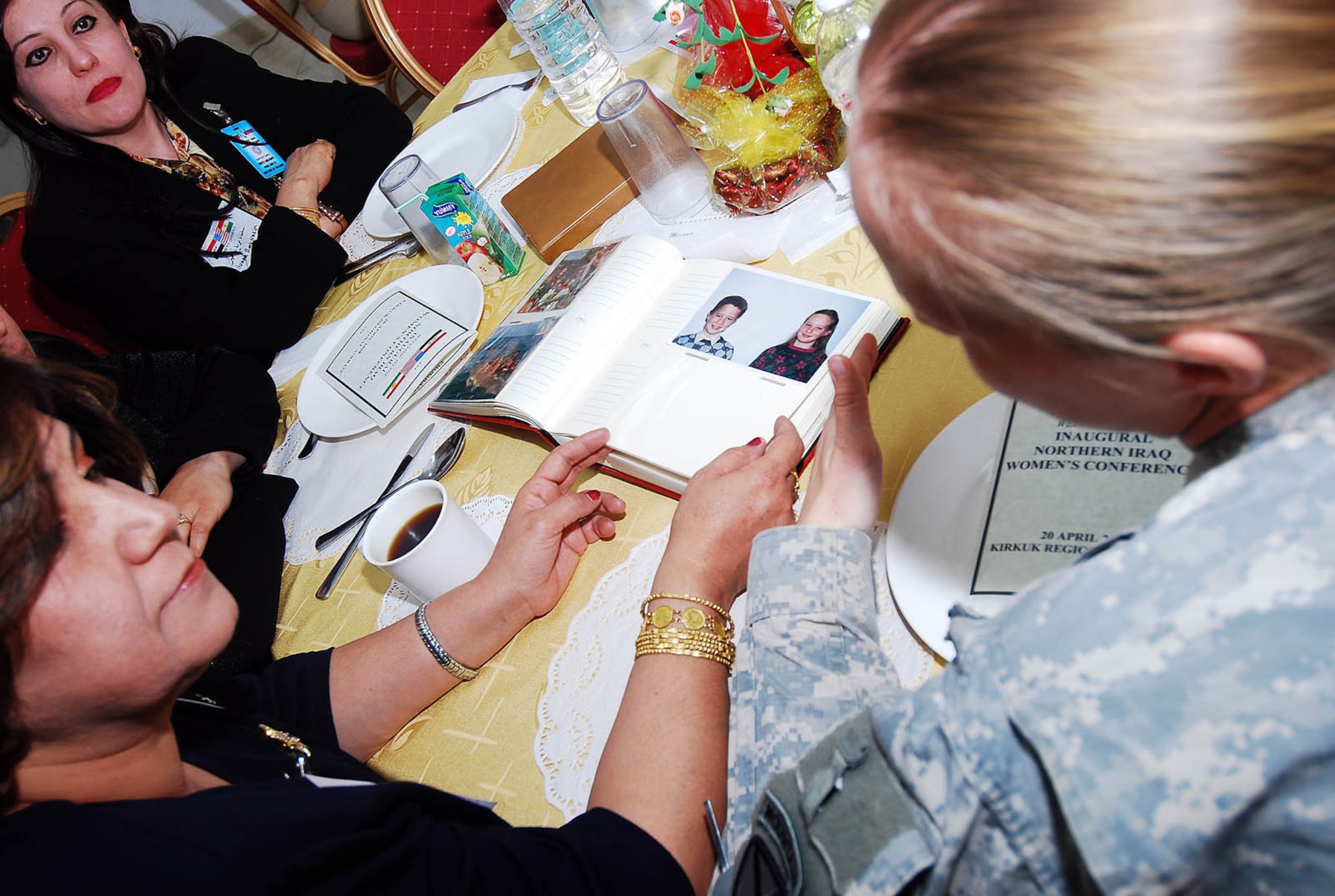 The dialogue remained light with more interest in getting to know one another as Soldiers and Airmen brought photo albums, sharing pictures of family and friends with attendees, who in turn, shared theirs at the Inaugural Northern Iraq Women's Conference held April 20, at FOB Warrior, Kirkuk, Iraq. (U.S. Army photo by Staff Sgt. Margaret C. Nelson)