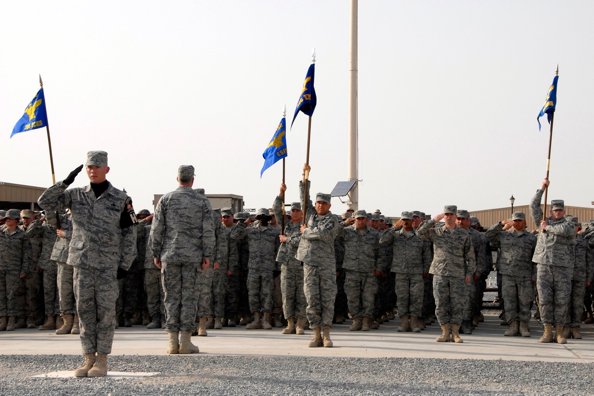 SOUTHWEST ASIA – Master Sgt. Daniel Young, 386th Expeditionary Communications Squadron first sergeant and team lead for the honor guard detail, prepares to lower his salute as Col. Richard Stonestreet, 386th Expeditionary Mission Support Group commander, faces the formation and issues the command to ‘Order Arms’ following the lowering of the American flag during an expedited retreat ceremony April 25, 2008, at an air base in the Persian Gulf Region. (U.S. Air Force photo/Tech. Sgt. Michael O’Connor)