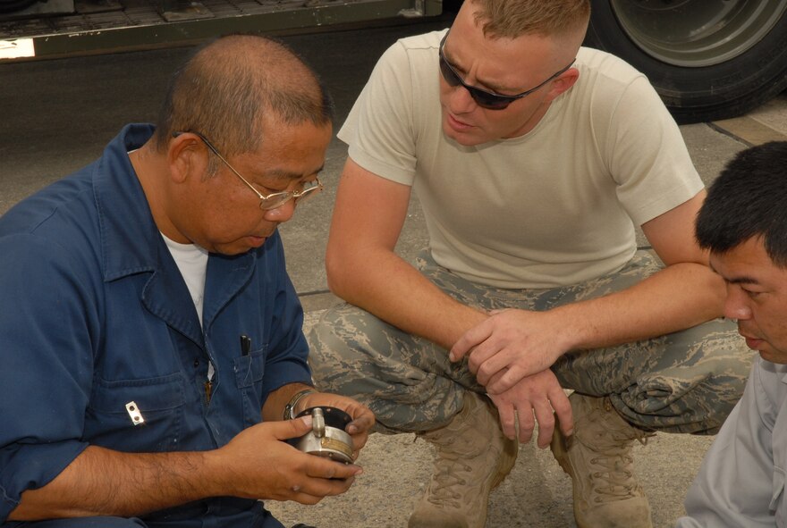 Satoshi Uza and Staff Sgt. Zebulan Tune, 18th Civil Engineering Squadron, inspect a fuel pump component at Kadena Air Base, Japan, April 22, 2008. Kadena's 18th Civil Engineer Group was awarded the Major General Robert H. Curtin Award as the most outstanding civil engineer unit in the Air Force. 
 (U.S. Air Force photo/Airman Chad Warren)