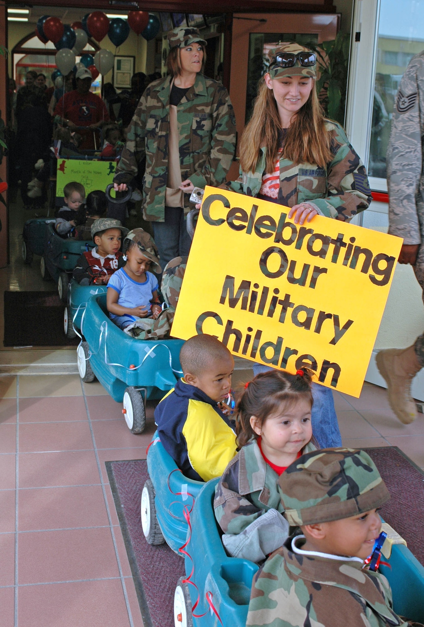AVIANO AIR BASE, Italy--Children from the toddler room wheel out for the annual month of the military child parade at Area 1. More than 200 children, teachers and parents dressed in fatigues, costumes and Uncle Sam hats for the parade. (U.S. Air Force photo/Senior Airman Justin Weaver).