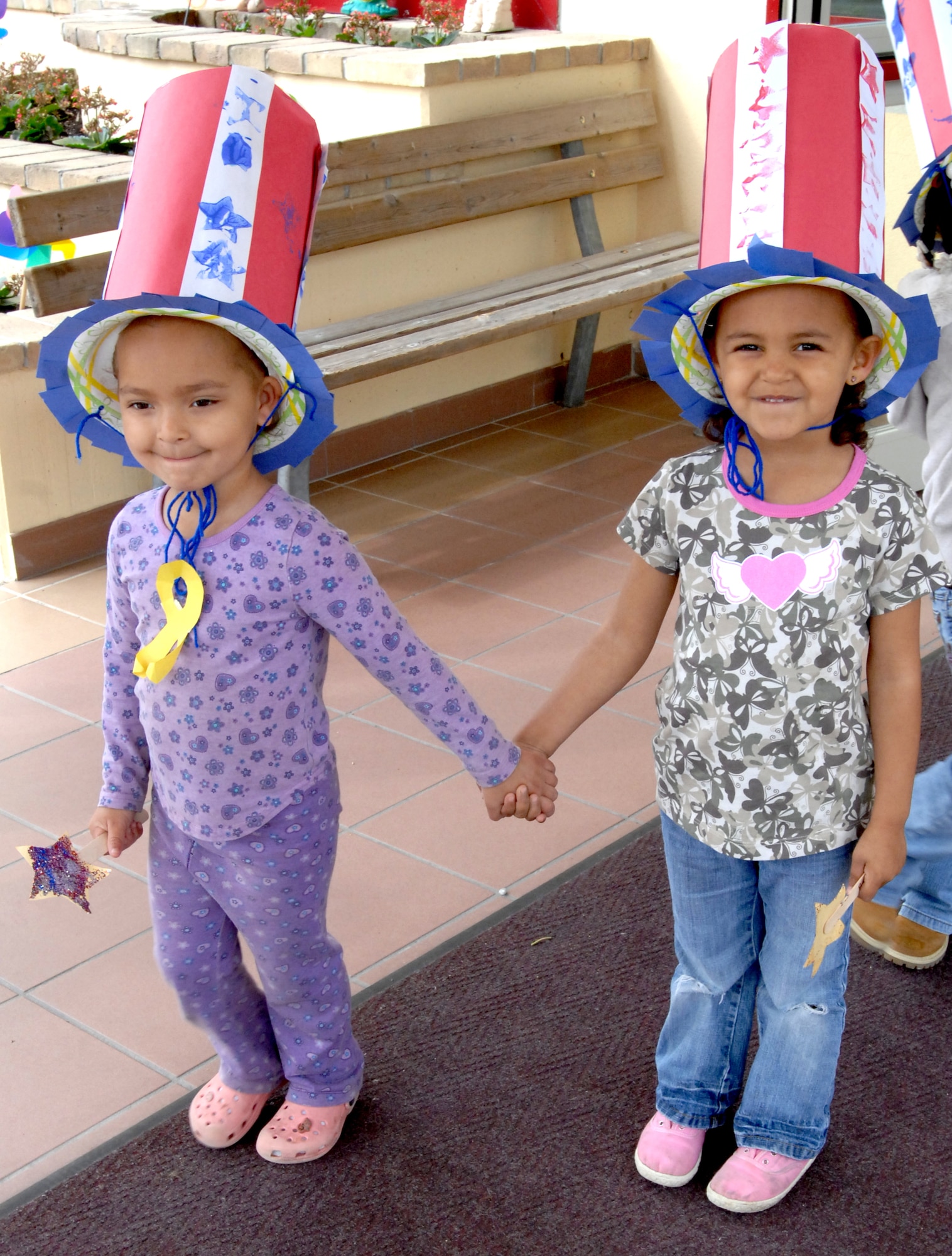 AVIANO AIR BASE, Italy--Decked out in Uncle Sam hats, MaKayla Lewis and Amaya Phillips get ready to march around Area 1 during the annual CDC military child parade.  (U.S. Air Force photo/Airman 1st Class Tabitha Mans).