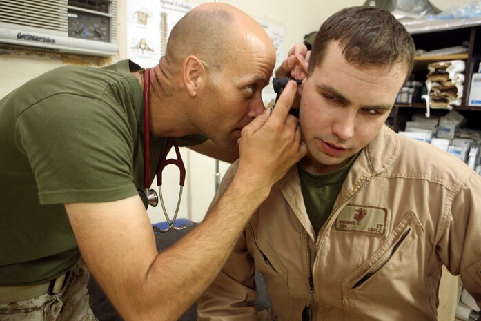 Chief Petty Officer Truman A. Gartman, chief petty officer of the Battalion Aid Station, 2nd Light Armored Reconnaissance, Regimental Combat Team 5, provides care for Cpl. Ian T. Wimmer, a communications chief with 1st Radio Battalion, I Marine Expeditionary Force (Fwd), during a routine work day at Camp Korean Village, Iraq, April 30. Gartman has served the Marines for over 14 years of his 20 years with the Navy.