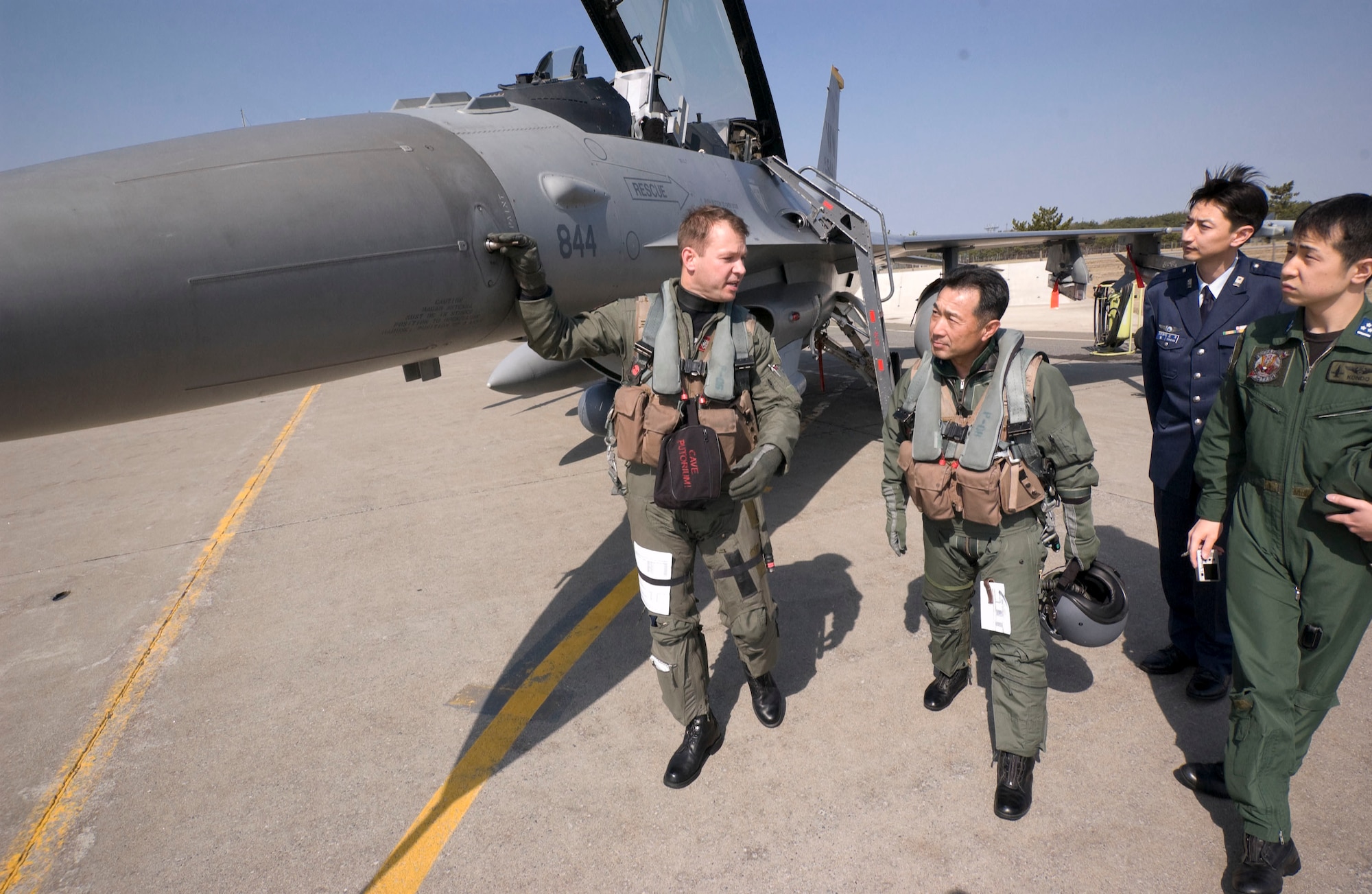 MISAWA AIR BASE, Japan -- Lt. Col. Stephen Williams, 13th Fighter Squadron commander, explains the various aspects of the F-16 fighter jet to Maj. Gen. Hideo Wakabayashi, Japan Air Self Defense Force 3rd Air Wing commander, during a preflight walk-around on April 15, 2008. Colonel Williams was familiarizing General Wakabayashi with the aircraft to promote understanding between the U.S. and Japanese Forces. (U.S. Air Force photo by Senior Airman Samuel Morse)
