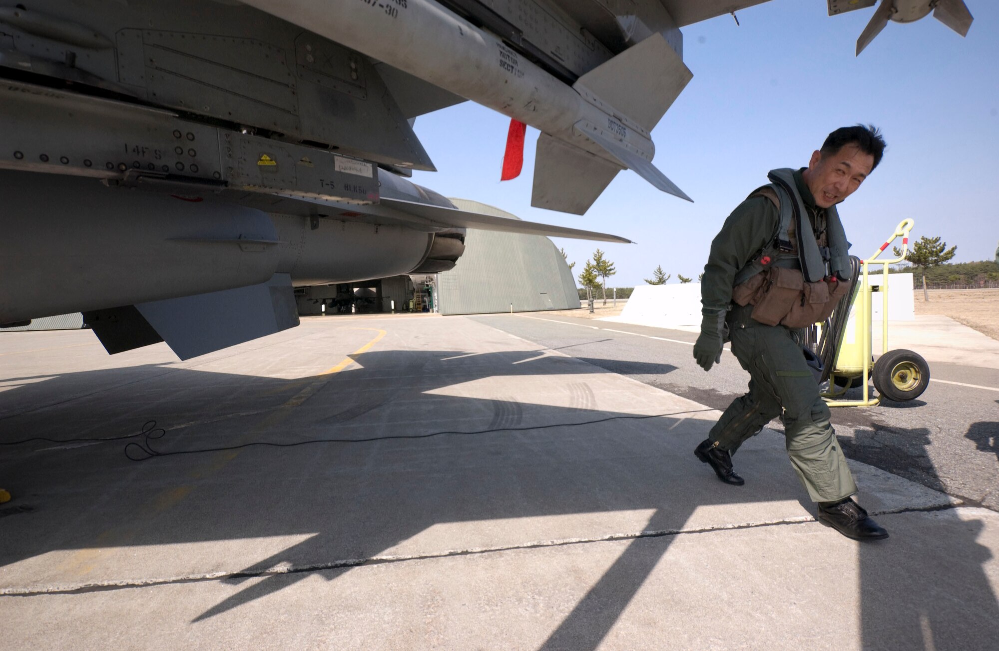 MISAWA AIR BASE, Japan -- Maj. Gen. Hideo Wakabayashi, Japan Air Self Defense Force 3rd Air Wing commander, walks around an F-16 fighter jet during preflight checks on April 15, 2008. General Wakabayashi was familiarizing himself with the F-16 as part of an exchange between the U.S. Air Force and Japan Air Defense Force at Misawa Air Base to better understand each other's capabilities. (U.S. Air Force photo by Senior Airman Samuel Morse)
