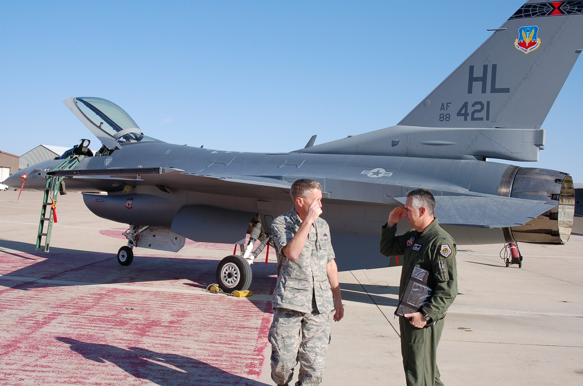 The final 388th Fighter Wing Block 40 F-16 to undergo Common Configuration Implementation Program upgrades is handed over to Col. Scott Dennis (right), 388th FW commander, in a ceremony April 21.  Beginning in November 2005, depot workers from the 309th Maintenance Wing, led by Brig. Gen. Art Cameron (left), invested over 5,500 maintenance hours into each of 388th FW's 72 aircraft.  CCIP brings upgraded avionics and communications systems to pilots in combat.  Hill's 4th Fighter Squadron was the first to fly CCIP F-16s in combat in August 2007.  (U.S. Air Force photo by Bill Orndorff) 