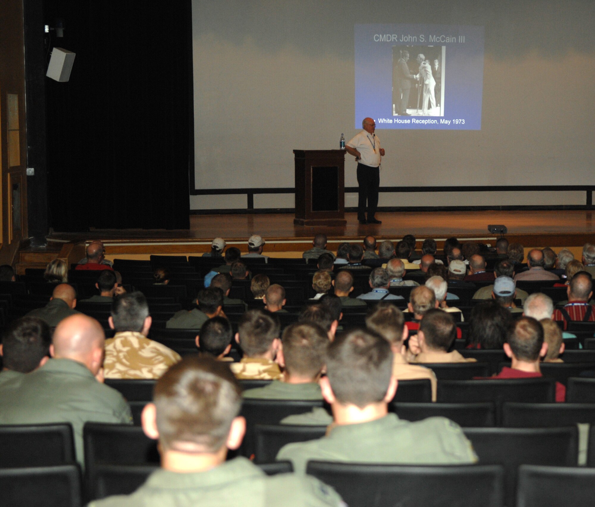 Retired Air Force Colonel Elmo "Mo" Baker, once a member of the 355th, shares his heroic story of being a POW during the Vietnam War with members of D-M April 25 at the base theater. (U.S. Air Force photo by Senior Airman Alesia Goosic)