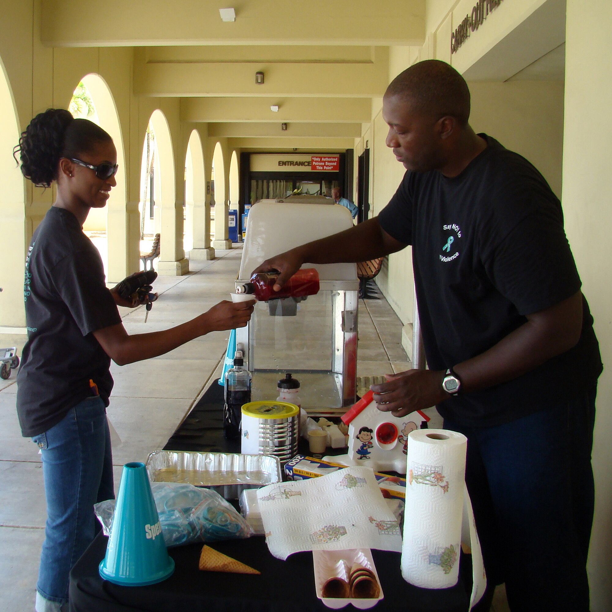 Staff Sergeant Terrence Baptiste 36th Mission Support Squadron supported Denim Day Apr. 25 by wearing the Denim Day t-shirt on sale throughout the month of April and serving free snow cones to other Denim Day participants in front of the base Commissary. (Courtesy photo by Shari Freeman)