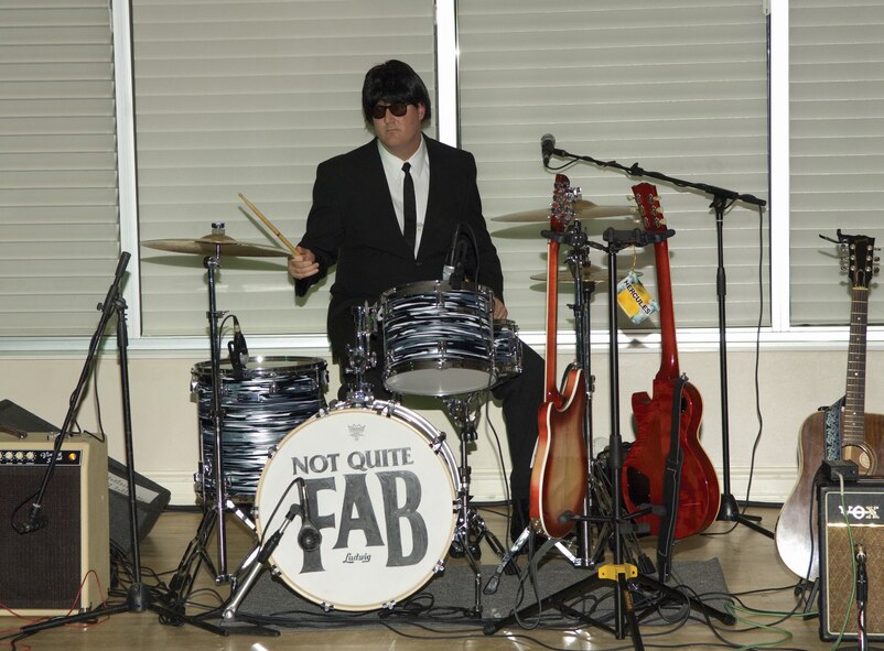 Chief Master Sgt. Jeffrey Fitzpatrick, former 719th Maintenance Squadron member, plays the drums alongside his three other band mates in the "Not Quite Fab" band at the 719th MXS farewell party earlier this month.