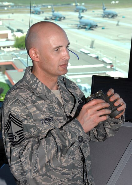 Chief Master Sergeant Johnny Turner, Tower Chief Controller scans the runway to insure a safe landing environment for an approaching aircraft at Travis Air Force Base, California.  USAF photo by Civ/Nan Wylie USAF 