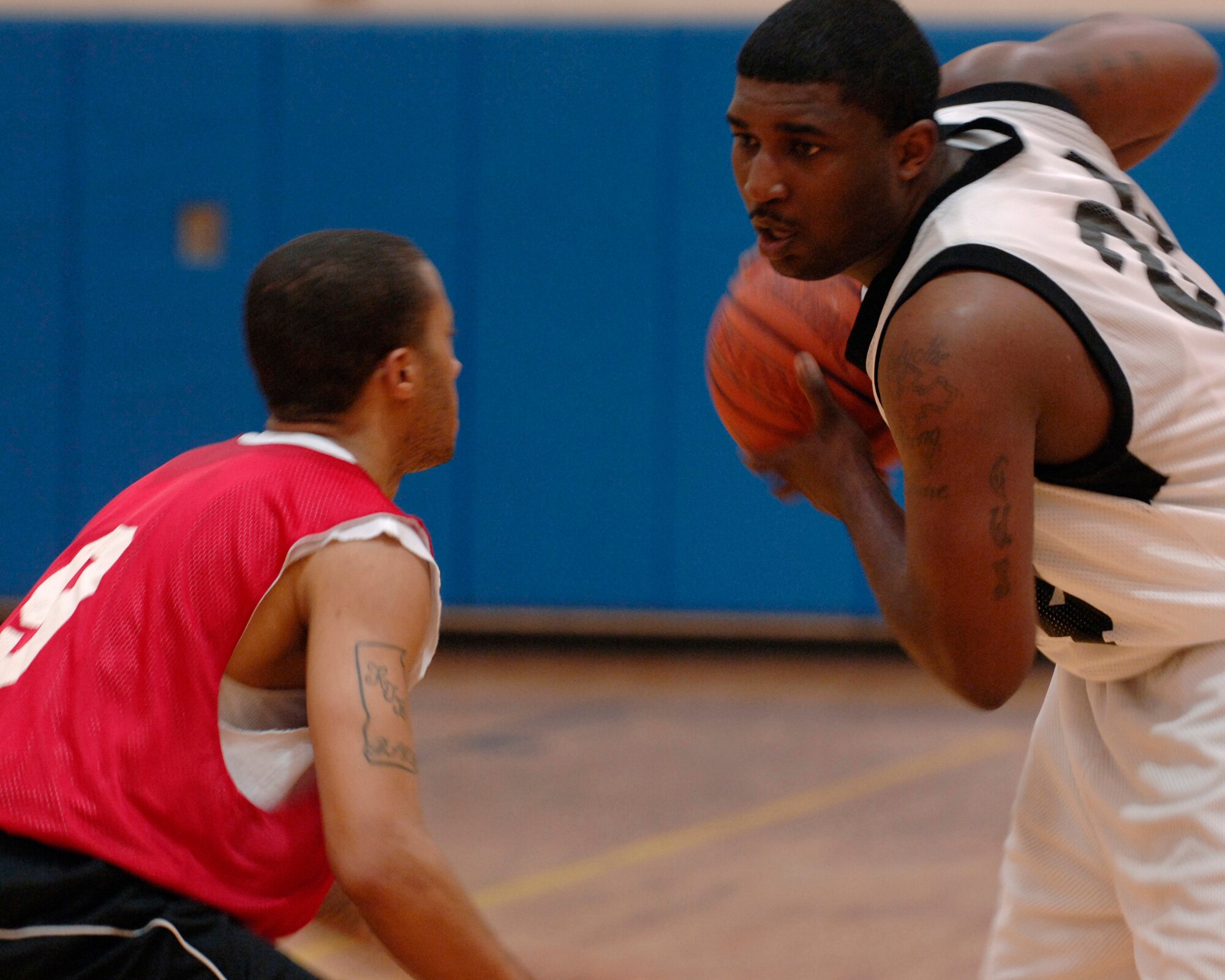 MOODY AIR FORCE BASE, Ga. – Staff Sgt. Donate Addison, 23rd Maintenance Operation Squadron unit training manager, sizes up his opponent Senior Airman Amos Daniels, 23rd Equipment Maintenance Squadron combat armament team member during the All-Star basketball game here April 24. Both were chosen to represent their leagues in an Intramural versus Over-30 basketball game. (U.S Air Force photo by Senior Airman Schelli Jones)