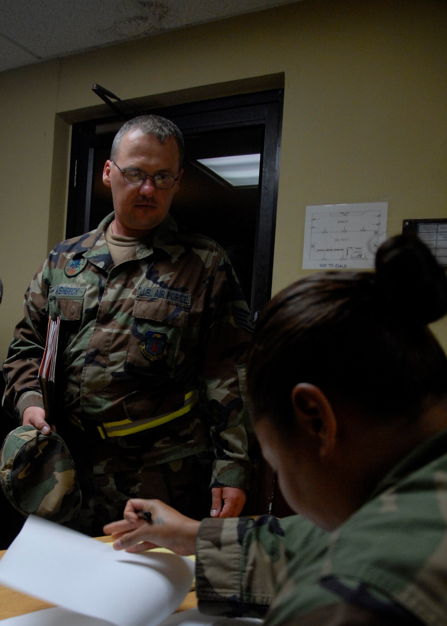 Airman 1st Class Shelley Walton, 36th Mission Support Squadron, verifies that Staff Sgt. Anthony Ashbeck, 36th Civil Engineer Squadron, is on a passenger manifest during the wing's Initial Response Readiness Exercise April 28. Before proceeding to the processing line for a pre-deployment briefing, each individual on the manifest must be accounted for. (U.S. Air Force photo/Staff Sgt. Patrick Mitchell)  