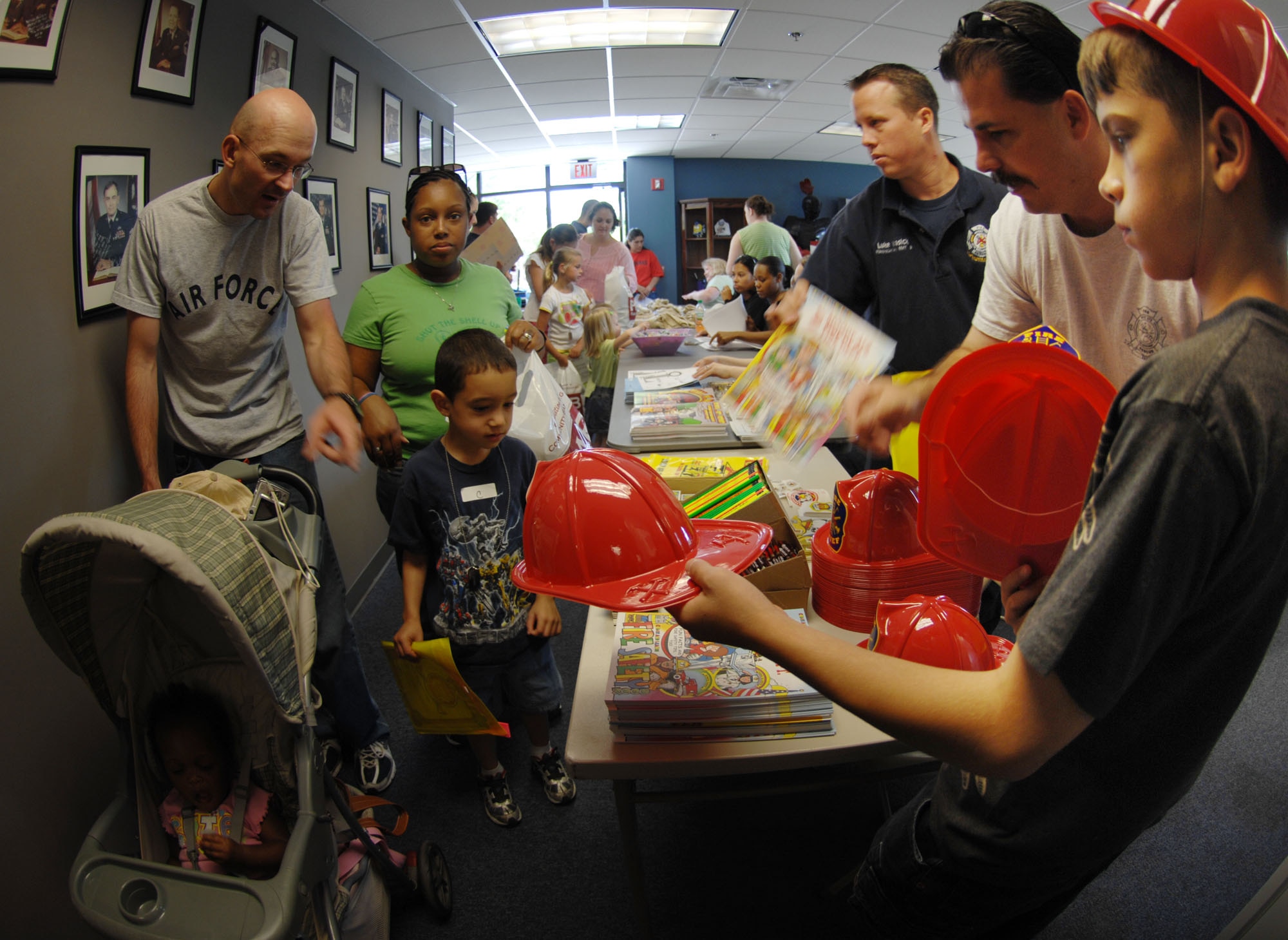 MOODY AIR FORCE BASE, Ga. – Fire fighters from the 23rd Civil Engineer Squadron pass out coloring books and hats during the kids deployment line here April 26.  Over 150 kids participated in the kid’s deployment line. (U.S. Air Force photo by Senior Airman Angelita Lawrence)