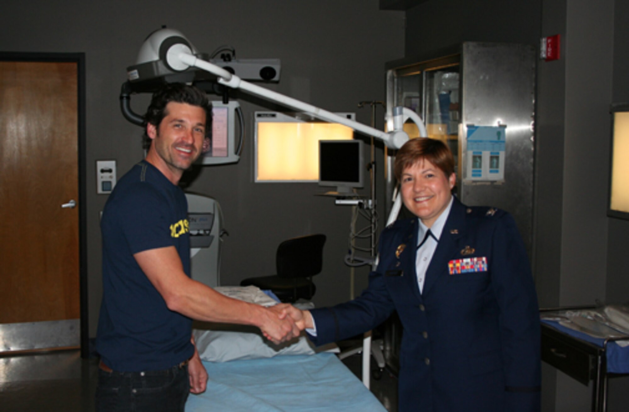61st Mission Support Group Commander Col. Nannette Benitez coins actor Patrick Dempsey on the set of Grey's Anatomy, April 17. 
