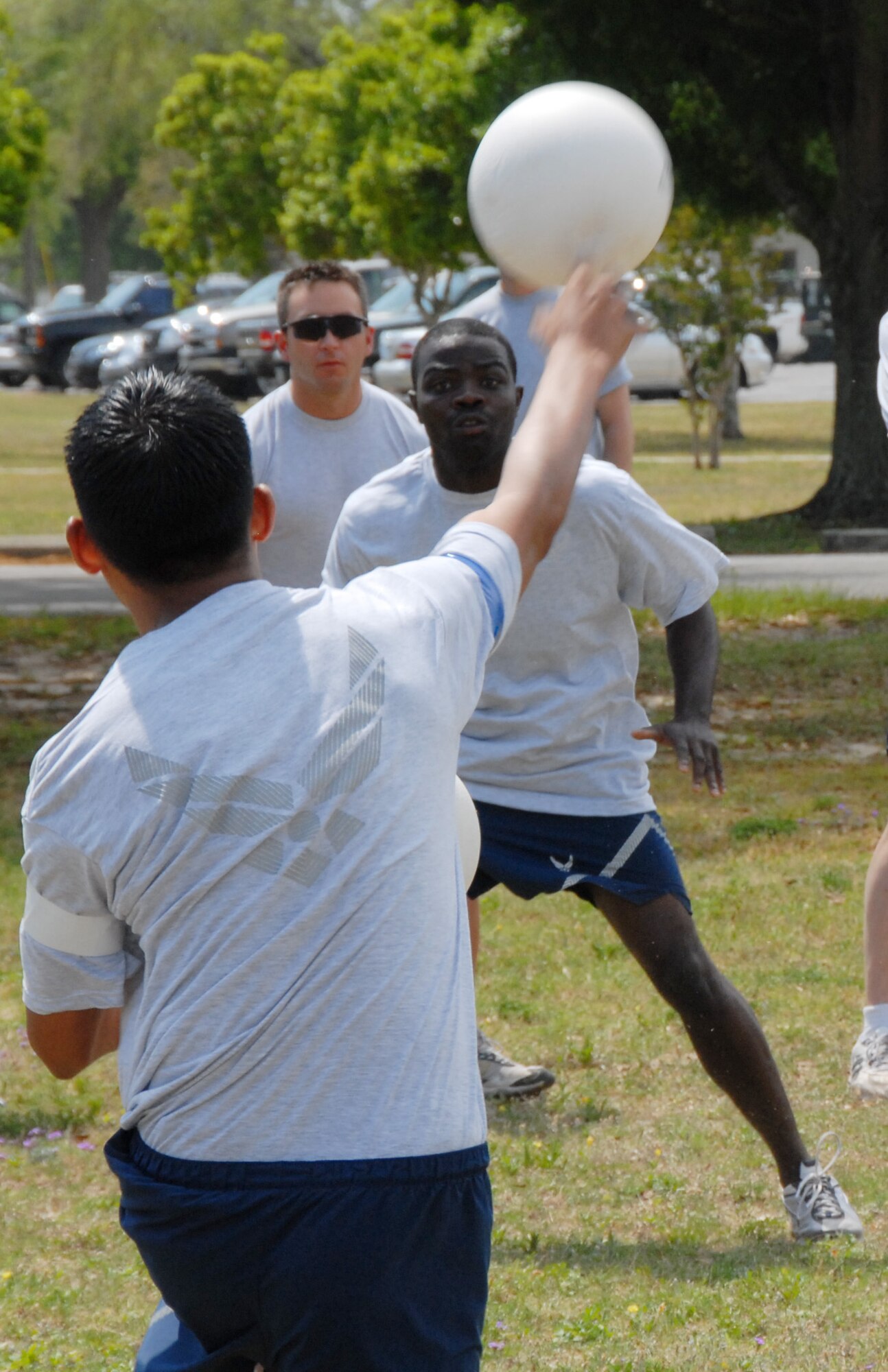 1st Lt. Brian An, 36th Electronic Warfare Squadron, launches a ball at Airman 1st Class Luc Antoine, 68th Electronic Warfare Squadron,  during the three-way volleyball competition during the 53d EWG Sports Day April 25 at Eglin Air Force Base, Fla.  Photo by Staff Sgt. Samuel King Jr.