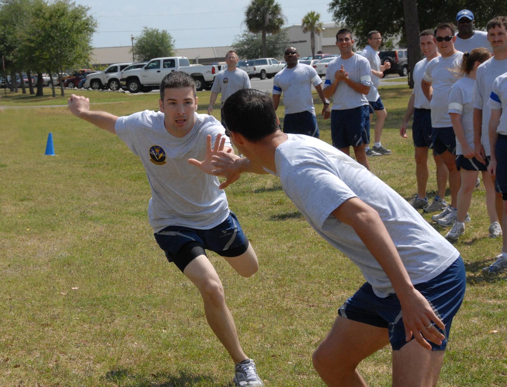 Staff Sgt. Jerimie Brown, 16th Electronic Warfare Squadron, tags in Staff Sgt. Eric Brown, 16th EWS, during the relay event at the 53d EWG Sports Day April 25 at Eglin Air Force Base, Fla.  Photo by Staff Sgt. Samuel King Jr.