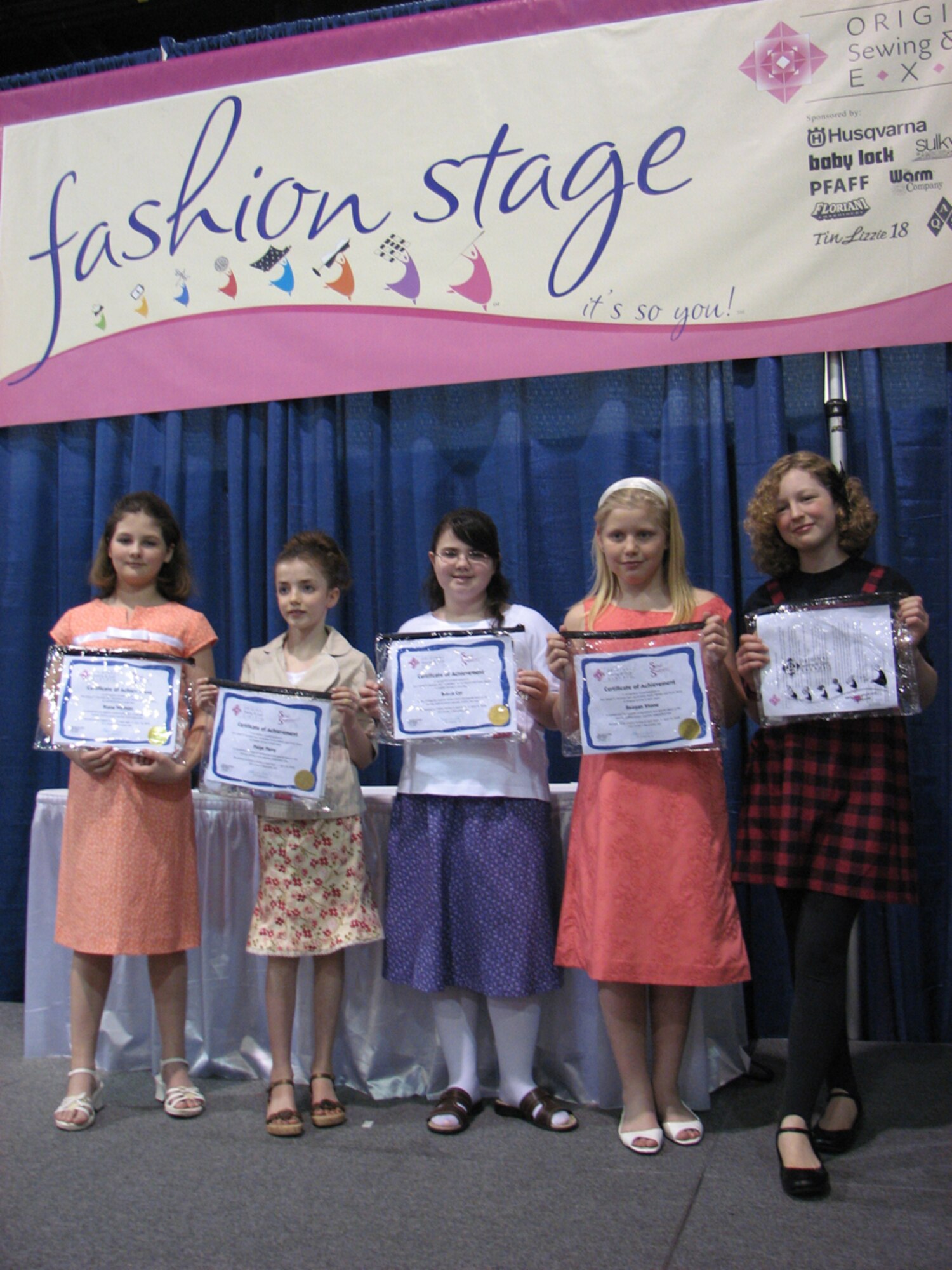 HANSCOM AFB, Mass. -- (From right to left) Riana Wirthlin, Paige Perry, Rebecca Cyr, Reagan Stone and Katy Murdock – Hanscom 4-H Club members -- model outfits that they made for a fashion show recently. The girls are made them as part of a Sewing Club project within 4-H. (Courtesy Photo)
