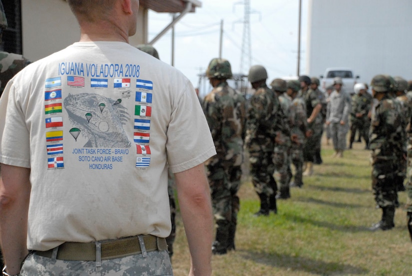 SOTO CANO AIR BASE, Honduras--Wearing a special event t-shirt, Army Lt. Col. Gregory Jicha, Iguana Voladora airborne commander, oversees the pre-jump instruction and familiarization the day before the jump. More than 135 paratroopers from 17 nations participated in this year's Iguana Voladora. (Photo by Tech. Sgt. William Farrow)