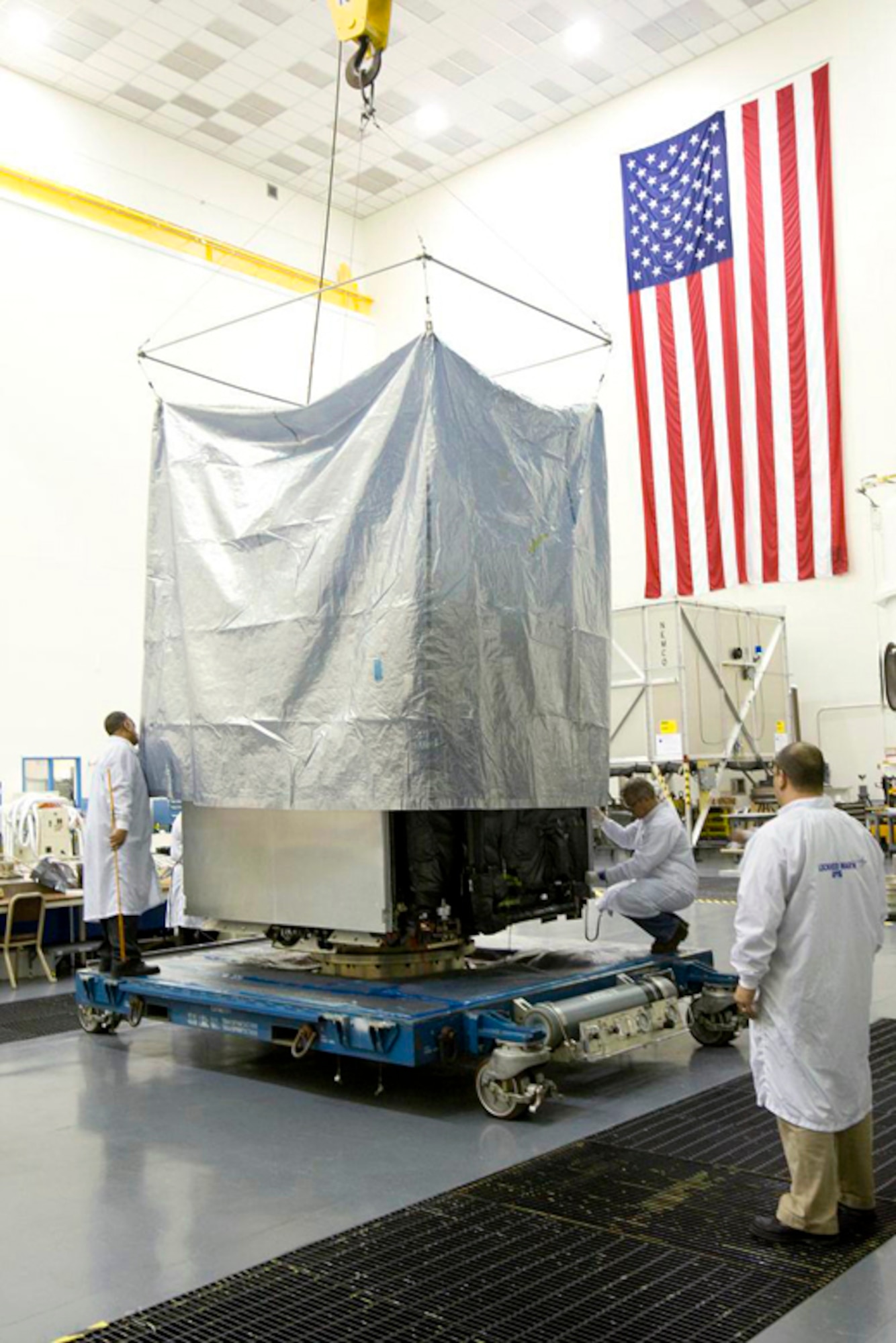 Employees at the Lockheed Martin plant in Valley Forge, Pa., prepare GPS IIR(M)-20 for shipment to Cape Canaveral Air Force Station, Fla.  The satellite, scheduled to launch June 30, is the last of the IIR-series GPS satellites the Air Force is receiving from Lockheed Martin. (Lockheed Martin photo/Stephen B. Griffin)