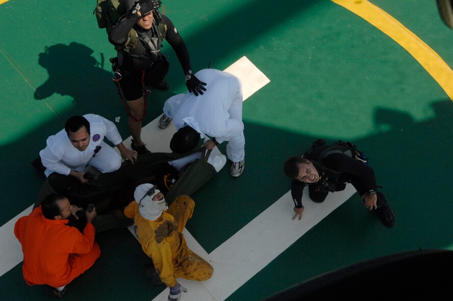 GULF OF MEXICO -- Pararescuemen from the 38th Rescue Squadron out of Moody Air Force Base, Ga., pick up survivors on a ship approximately 260 miles south of New Orleans, La., during a rescue mission April 25. (U.S. Air Force photo by Senior Airman Gina Chiaverotti) 
