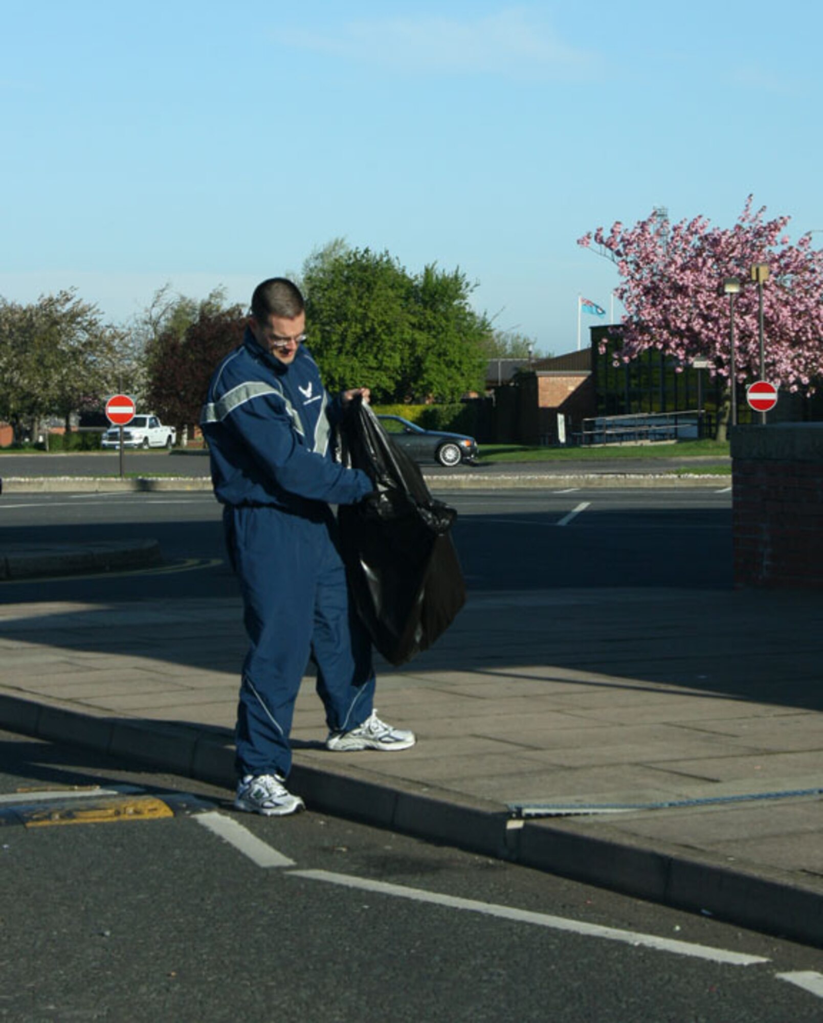 Lt. Col. Keith Welch, 423rd Civil Engineer Squadron commander, picks up cigarette butts outside the bowling alley at RAF Alconbury. Base members fanned out across the base to pick up trash and other debris as part of the Tri-Base Earth Day event.