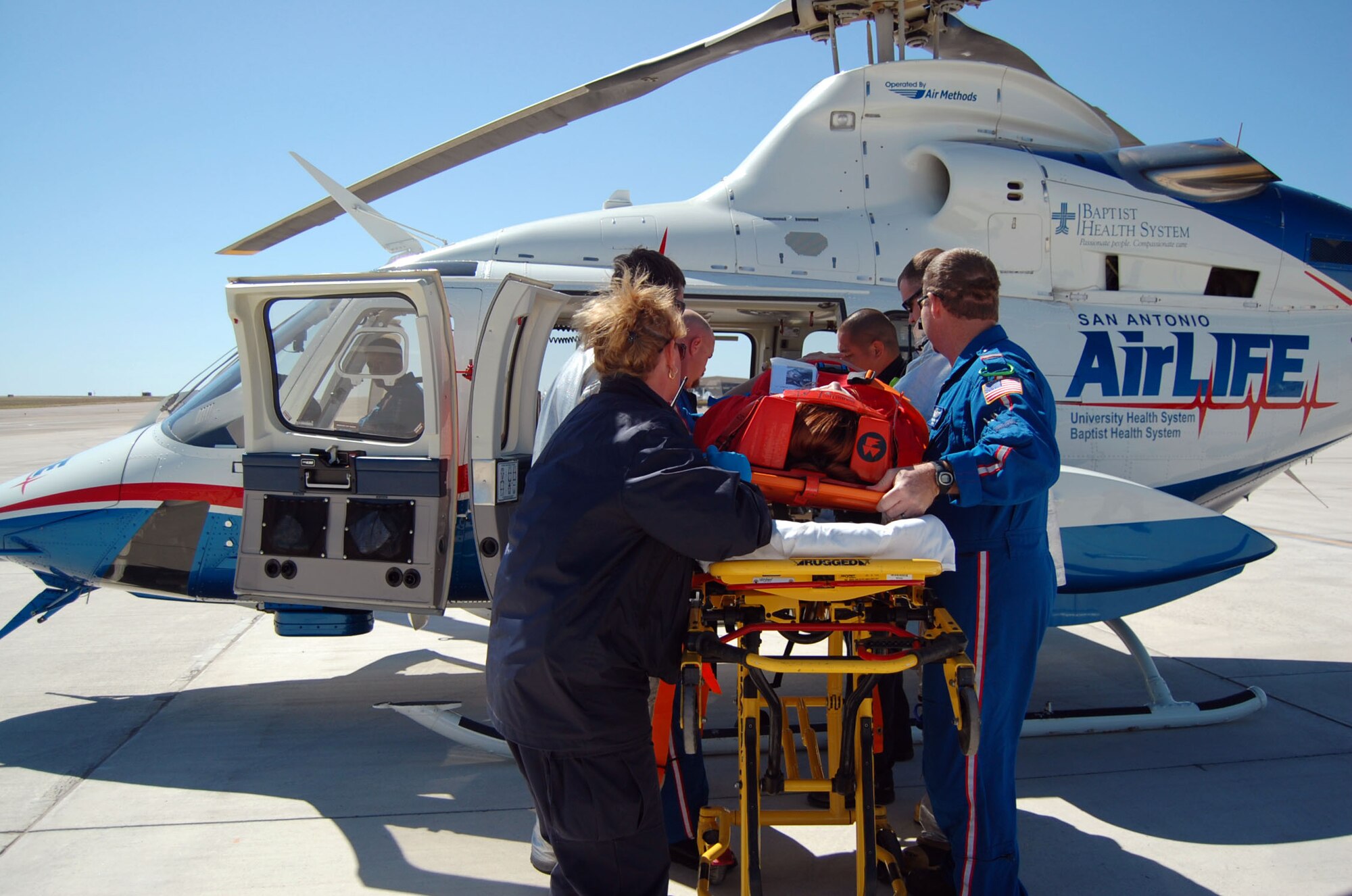 LAUGHLIN AIR FORCE BASE, Texas – Del Rio emergency support and members of the Air Life crew from San Antonio load a Laughlin member with simulated injuries during the exercise here April 18. Laughlin conducted multiple exercises to prepare for an upcoming air show May 10. (U.S. Air Force photo by Airman 1st Class Sara Csurilla)