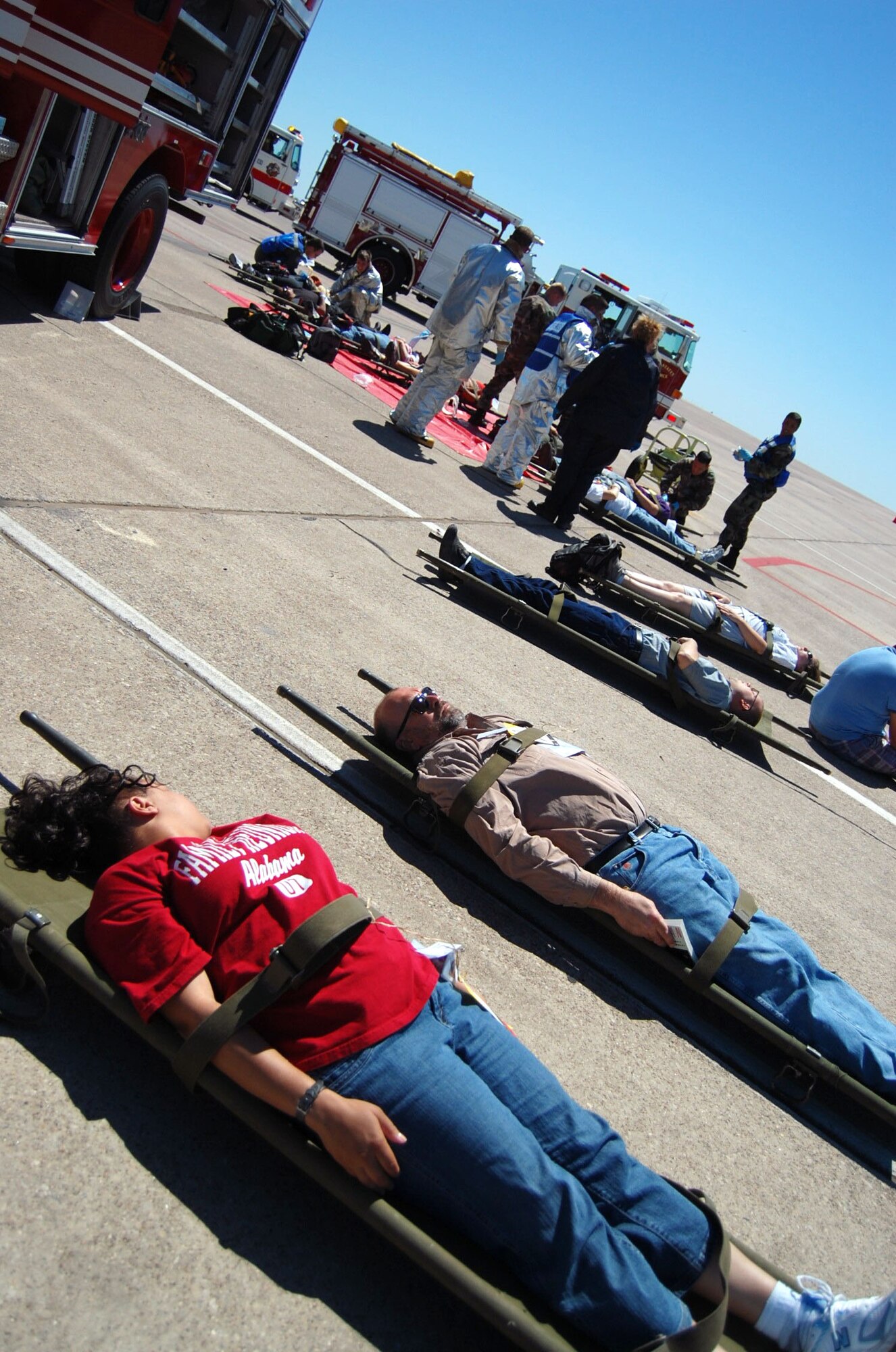 LAUGHLIN AIR FORCE BASE, Texas – Simulated victims of a replica plane crash await medical attention in front of Laughlin’s fire trucks and Del Rio’s ambulances during the exercise here April 18. Laughlin conducted multiple exercises to prepare for an upcoming air show May 10. (U.S. Air Force photo by Airman 1st Class Sara Csurilla)
