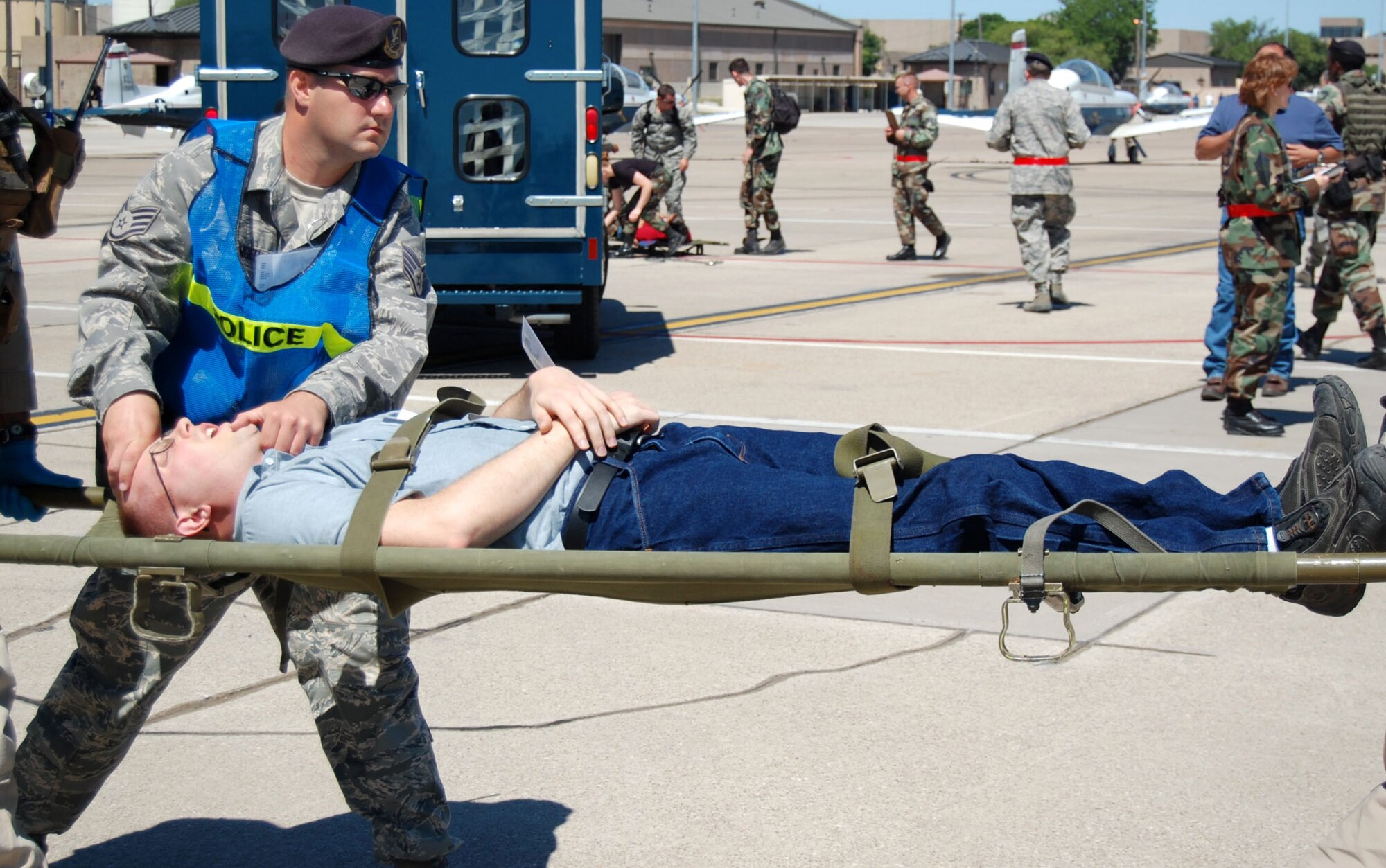 LAUGHLIN AIR FORCE BASE, Texas – Staff Sgt. Nicholas Ehlinger, 47th Security Forces Squadron, applies self-aid buddy care to a victim of the simulated plane crash on the flight line during an exercise conducted here April 18. Laughlin conducted multiple exercises to prepare for an upcoming air show May 10. (U.S. Air Force photo by Airman 1st Class Sara Csurilla)