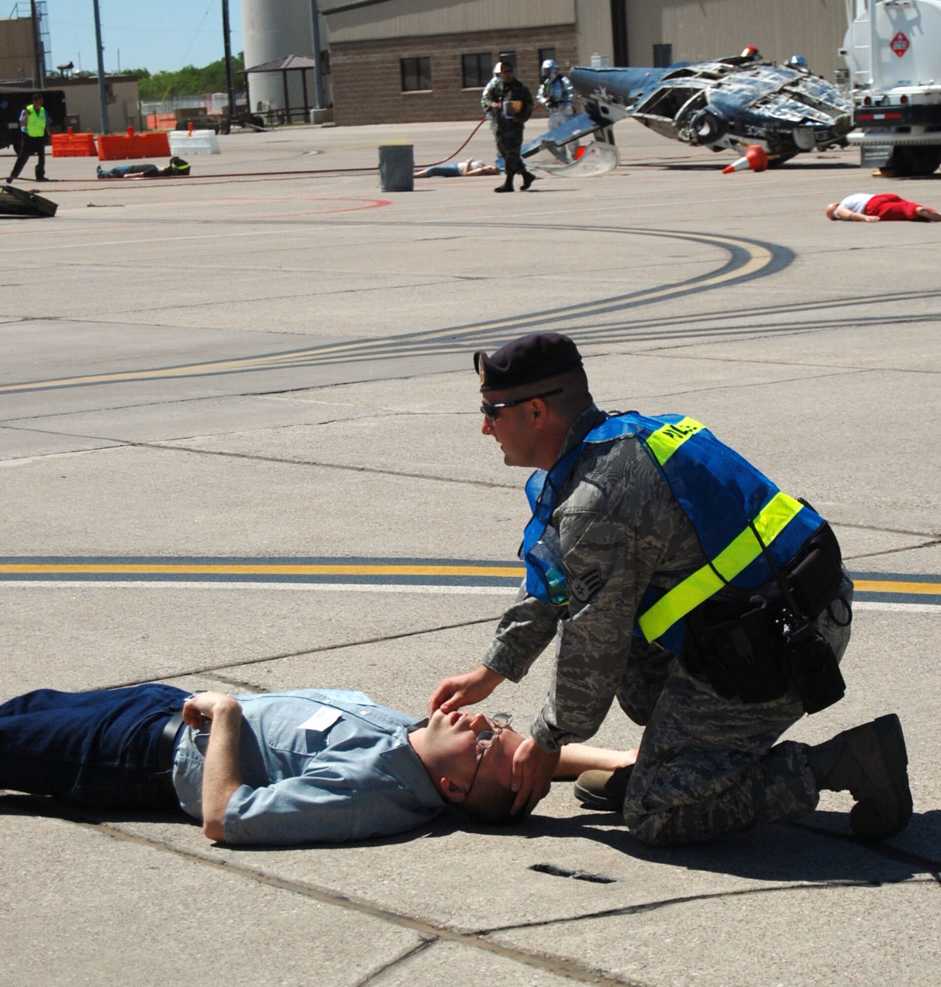 LAUGHLIN AIR FORCE BASE, Texas – Staff Sgt. Nicholas Ehlinger, 47th Security Forces Squadron, applies self-aid buddy care to a victim of the simulated plane crash on the flight line during an exercise conducted here April 18. Laughlin conducted multiple exercises to prepare for an upcoming air show May 10. (U.S. Air Force photo by Airman 1st Class Sara Csurilla)