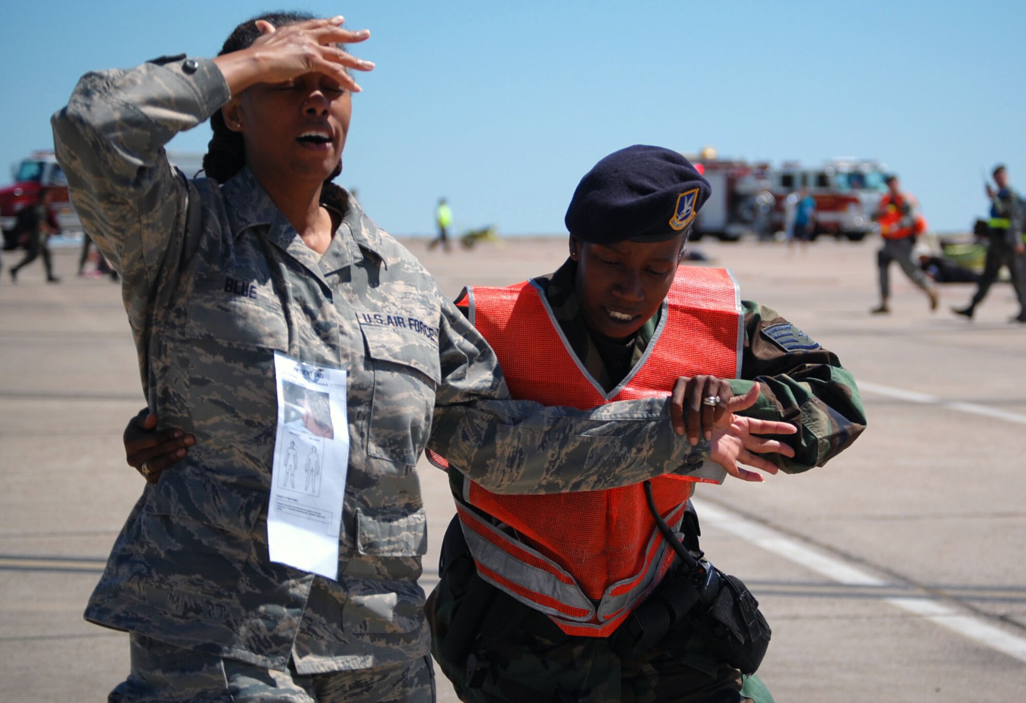 LAUGHLIN AIR FORCE BASE, Texas – Staff Sgt. Carroll Savoury-Groves, 47th Security Forces Squadron escorts Master Sgt. Tannya Blue, a simulated plane crash victim, off the flight line to an ambulance during an exercise conducted here April 18. Laughlin conducted multiple exercises to prepare for an upcoming air show May 10. (U.S. Air Force photo by Airman 1st Class Sara Csurilla)