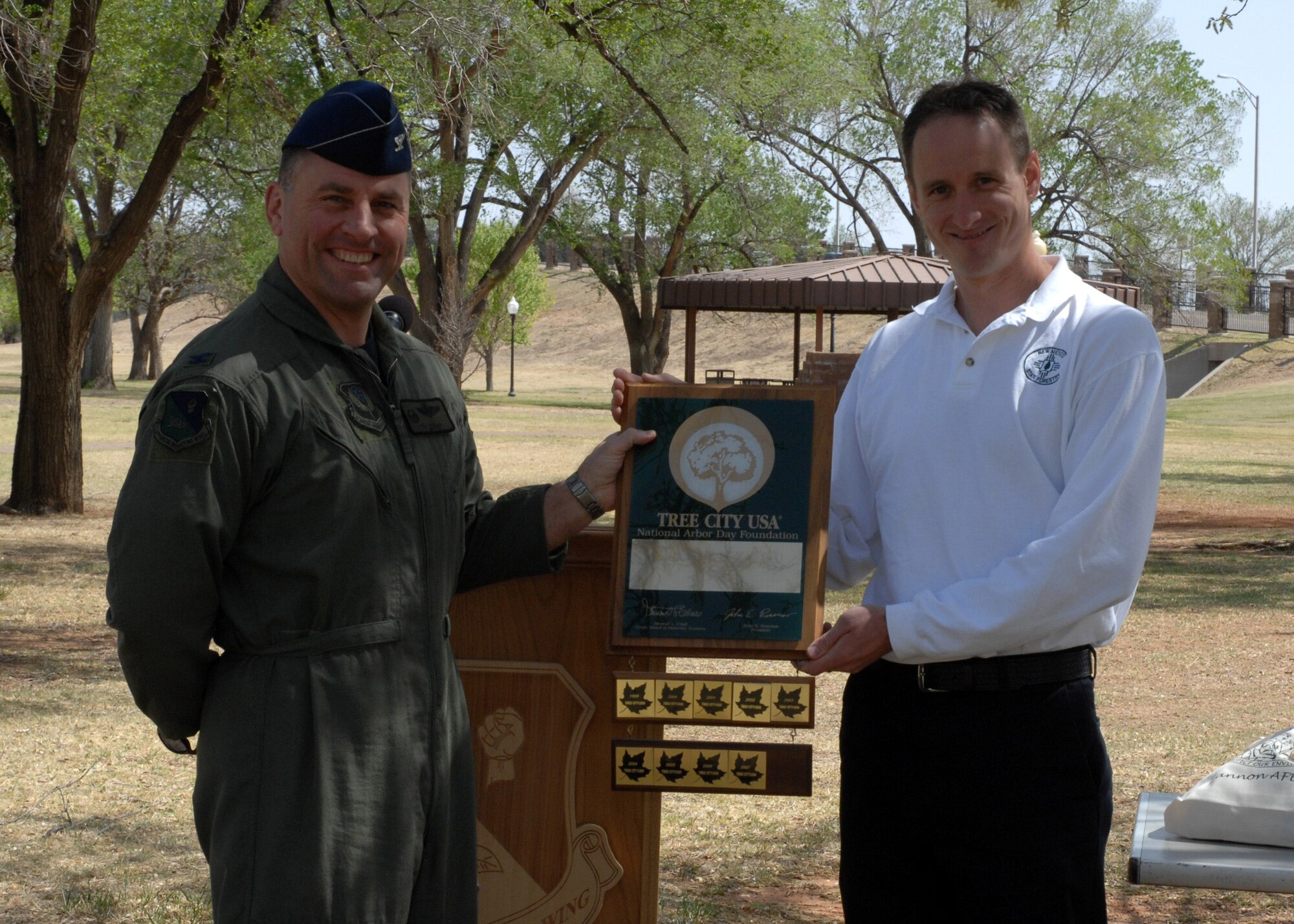 CANNON AIR FORCE BASE, N.M.--  Mr. Lance Davisson, New Mexico State Forestry Department presents Col. Timothy J. Leahy, 27th Special Operations Wing commander, with the Tree City USA national recognition plaque April 25. During the Arbor Day ceremony Cannon was recognized for its 10-year contribution to Tree City USA. (U.S. Air Force photo/Airman 1st Class Evelyn Chavez) 
