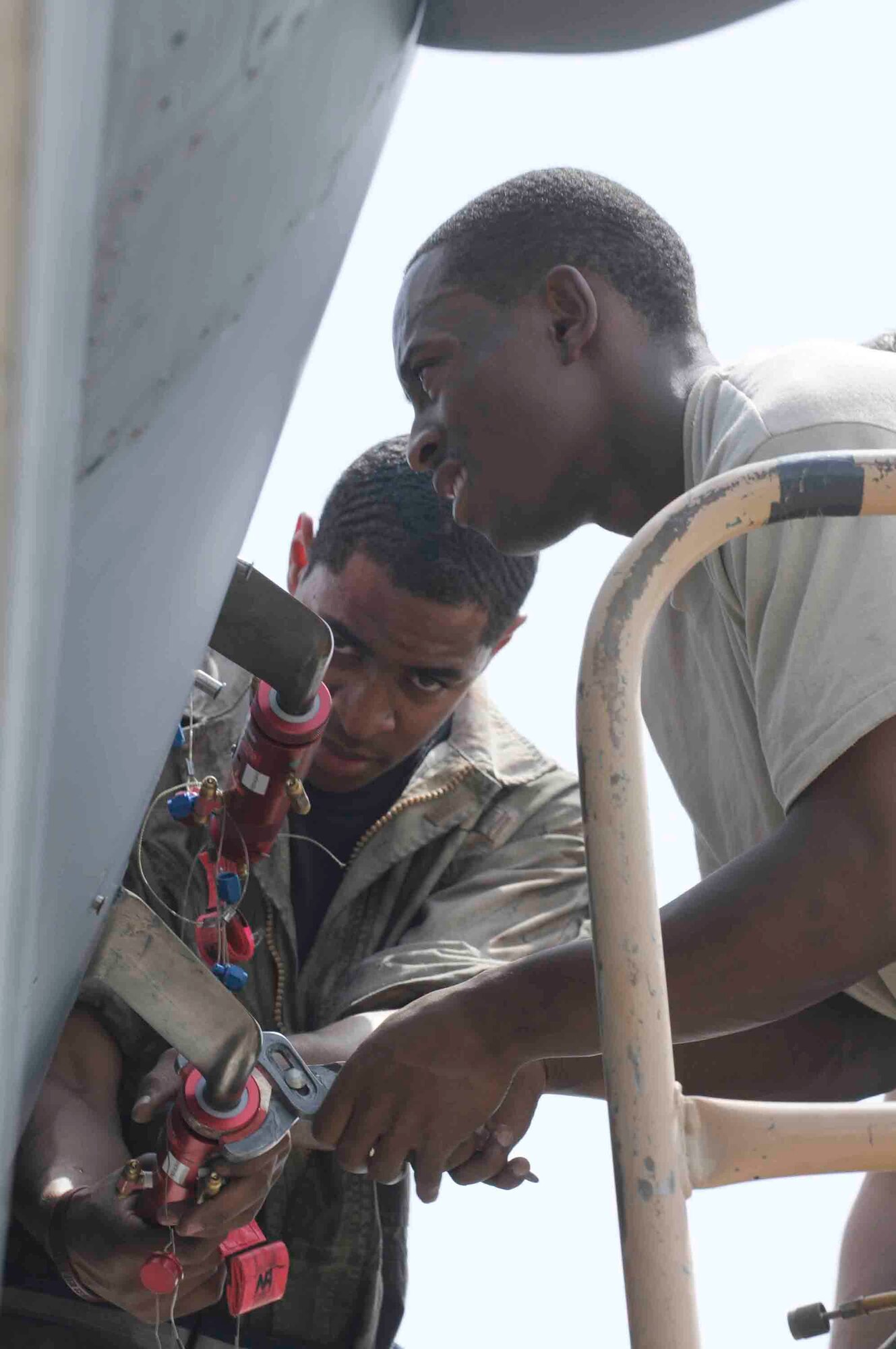 Airman 1st Class Nasr Bey and Airman 1st Class Marke St. Hill, 379th Expeditionary Maintenance Squadron, connect a test kit to B-1 Lancer at a Southwest Asia air base April 24. Test kits ensure aircraft systems measure air data properly while in flight. Both are deployed from Ellsworth Air Force Base, S.D.   (U.S. Air Force photo/Tech. Sgt. Johnny L. Saldivar)
