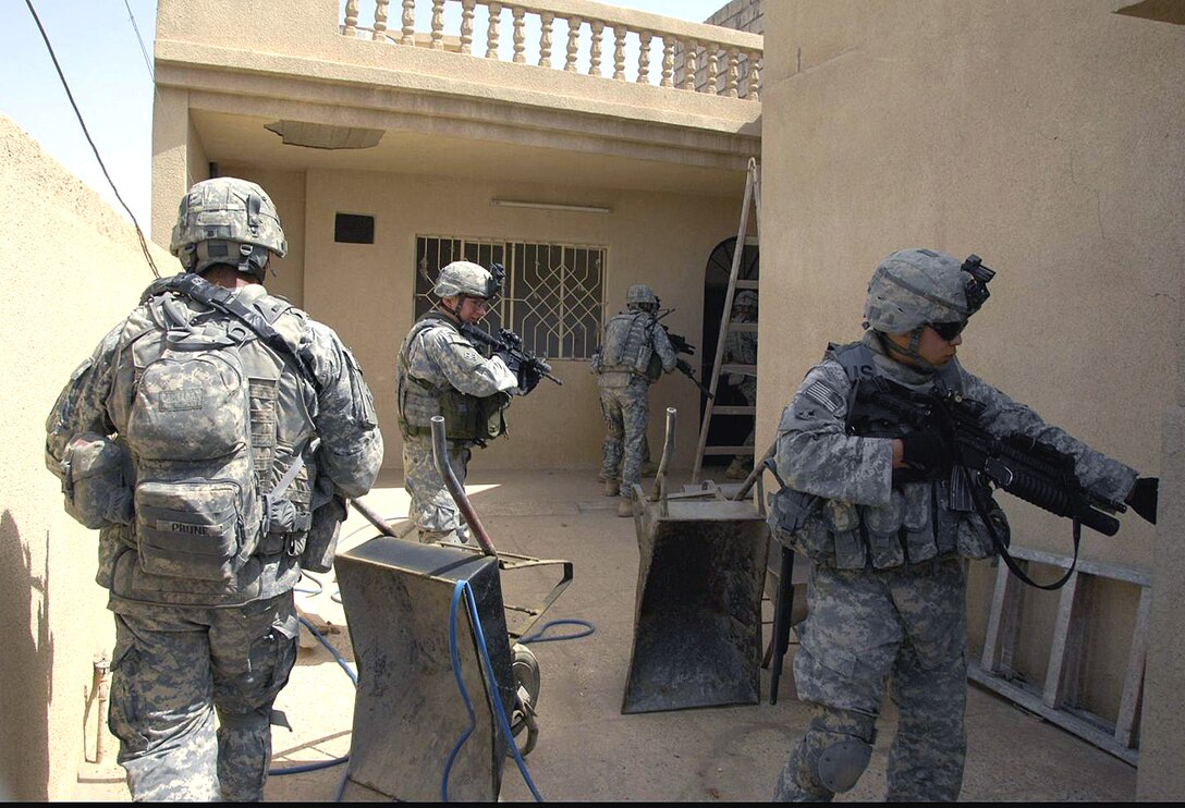 U.S. Army soldiers clear a building while performing a cordon and search for bombs and weapon paraphernalia in the neighborhood of Younis Al Sabawi in Mosul, Iraq April 23, 2008. 