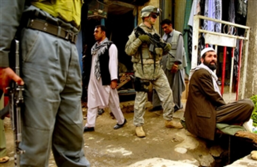 U.S. Air Force Senior Airman Mark Ostrander monitors residential traffic during a foot patrol in Charikar, Afghanistan, April 22, 2008. Ostrander is assigned to the police advisory team of the Charikar Provincial Reconstruction Team and is deployed from the 55th Security Forces Squadron, Offutt Air Force Base, Neb. 