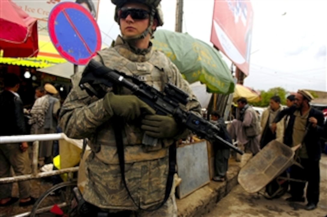 U.S. Air Force Senior Airman Mark Ostrander monitors residential traffic during a foot patrol in Charikar, Afghanistan, April 22, 2008. Ostrander, assigned to the 55th Security Forces Squadron, is attached to the Charikar Provincial Reconstruction Team's police advisory  team.
